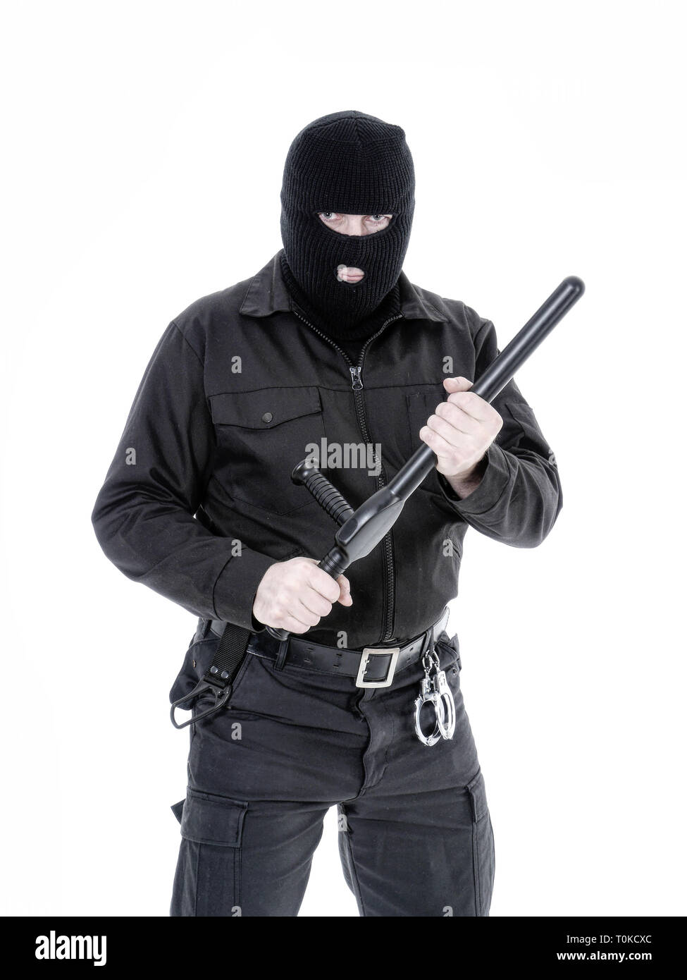 La police antiterroriste mec uniforme noir et noir balaclava holding police club fermement à deux mains, shot on white Banque D'Images
