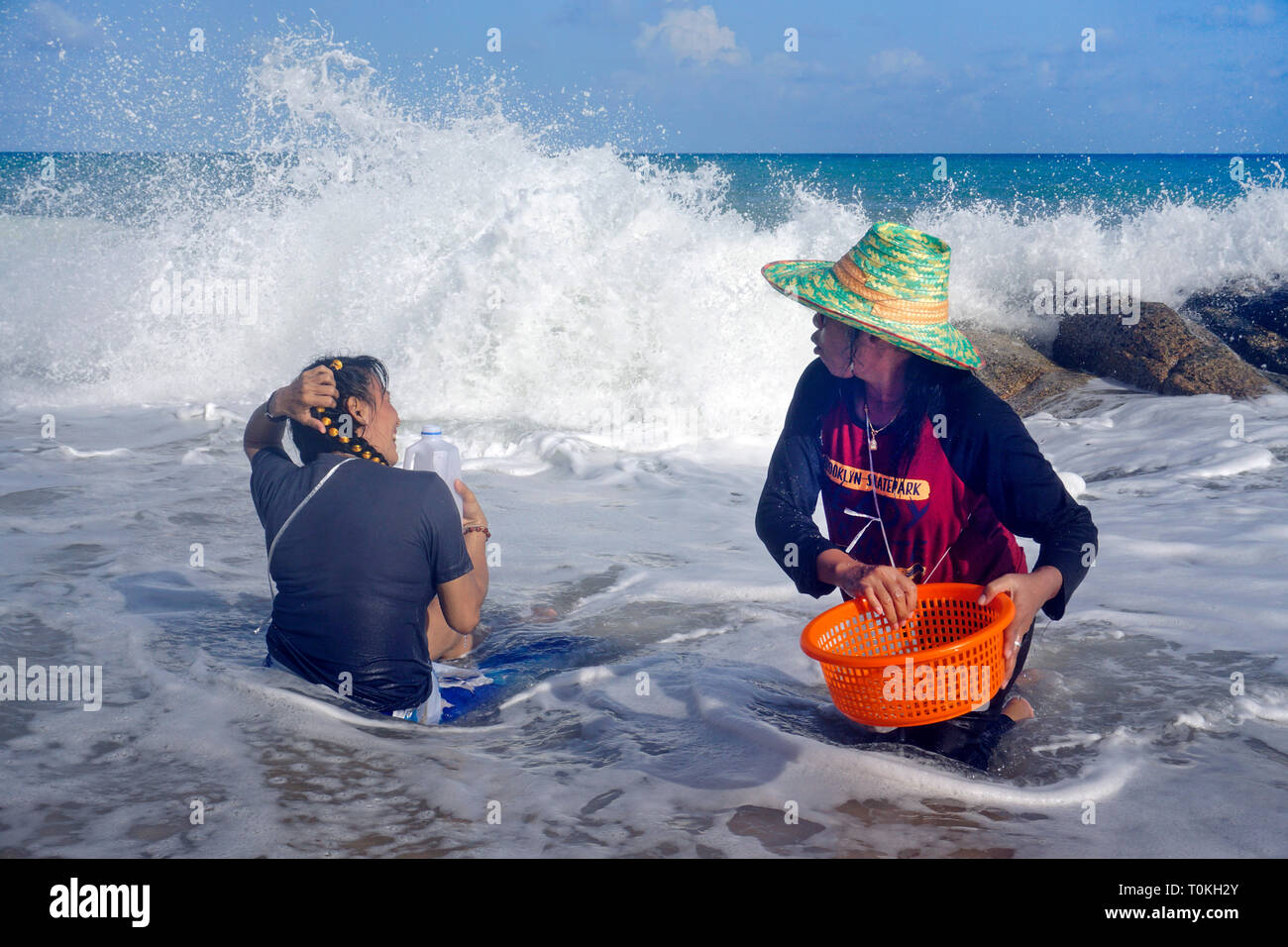 Les femmes thaïlandaises à creuser pour les moules à la plage, Lamai Beach, Koh Samui, Golfe de Thailande, Thaïlande Banque D'Images