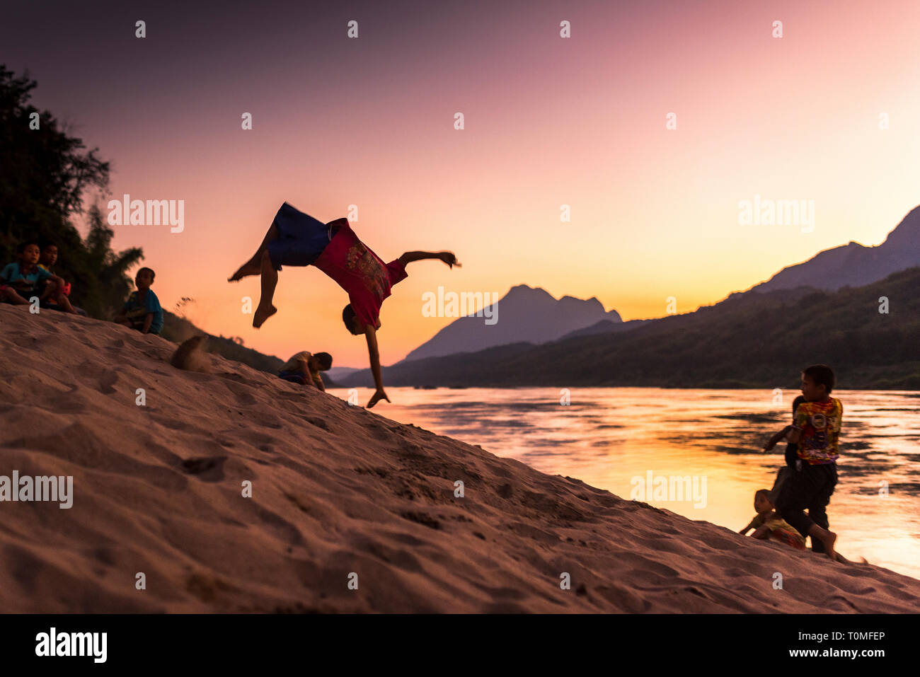 Backflip sur les rives du Mékong, au coucher du soleil, le Laos Banque D'Images