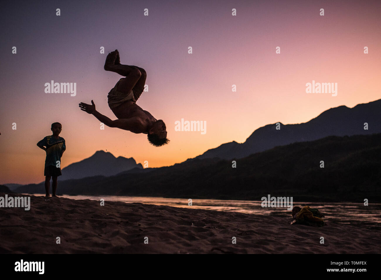 Backflip sur les rives du Mékong, au coucher du soleil, le Laos Banque D'Images