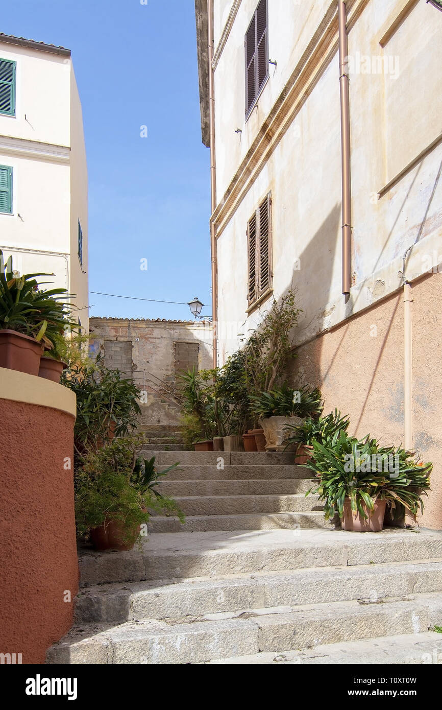 Escaliers et les bâtiments dans la zone portuaire dans des ruelles lors d'une journée ensoleillée à La Maddalena, en Sardaigne, Italie. Banque D'Images