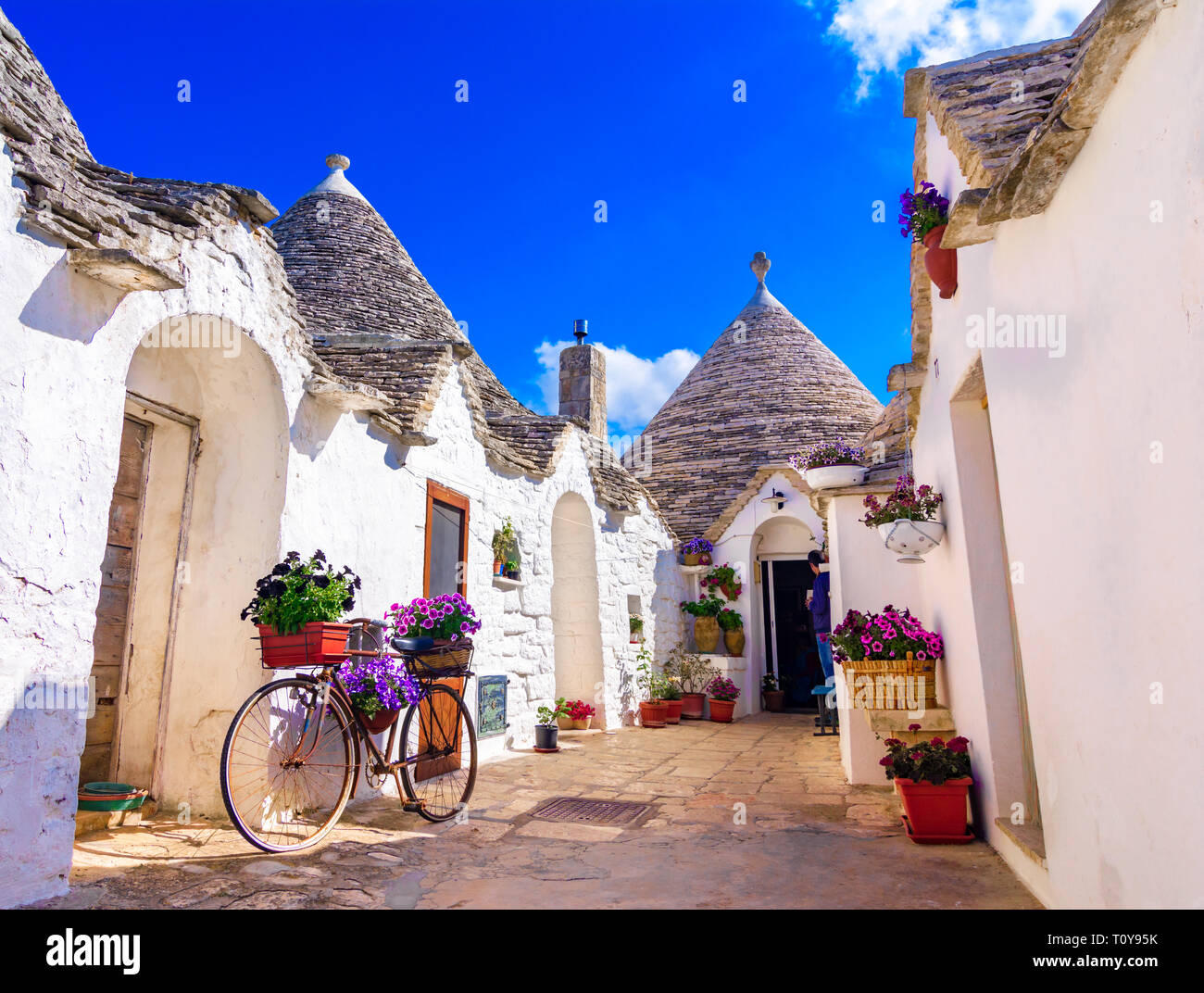 Alberobello, dans les Pouilles, Italie : maisons typiques construites avec des murs en pierre et des toits coniques, dans un beau jour, Pouilles Banque D'Images