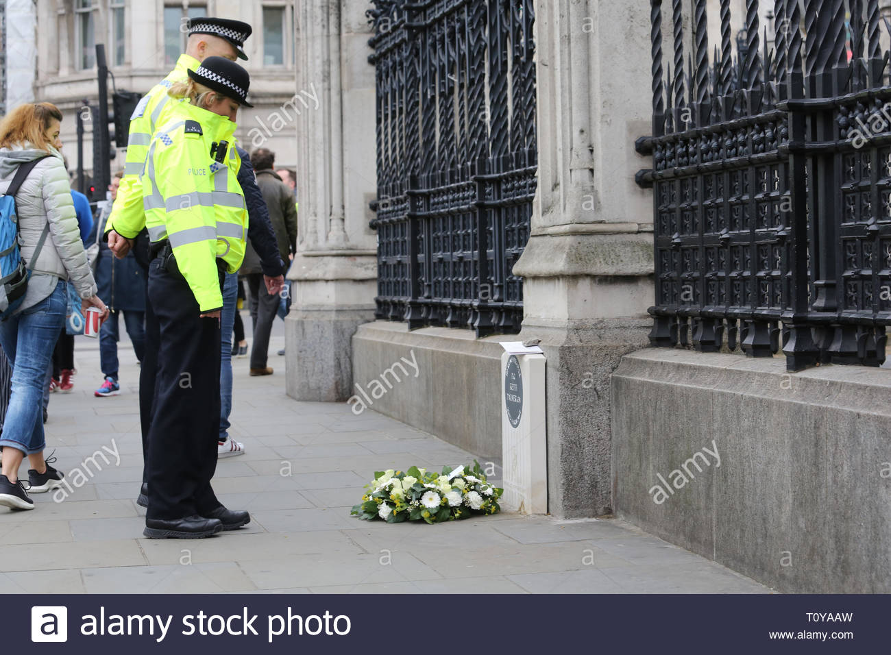 Londres, Royaume-Uni. Mar 22, 2019. Les agents de police de faire une pause à la mémoire de PC Keith Palmer à Westminster. C'est aujourd'hui le deuxième anniversaire de sa mort survenue au cours de l'attaque sur le pont de Londres et de fleurs fraîches ont été placés là. Crédit : la double couche/Alamy Live News Banque D'Images