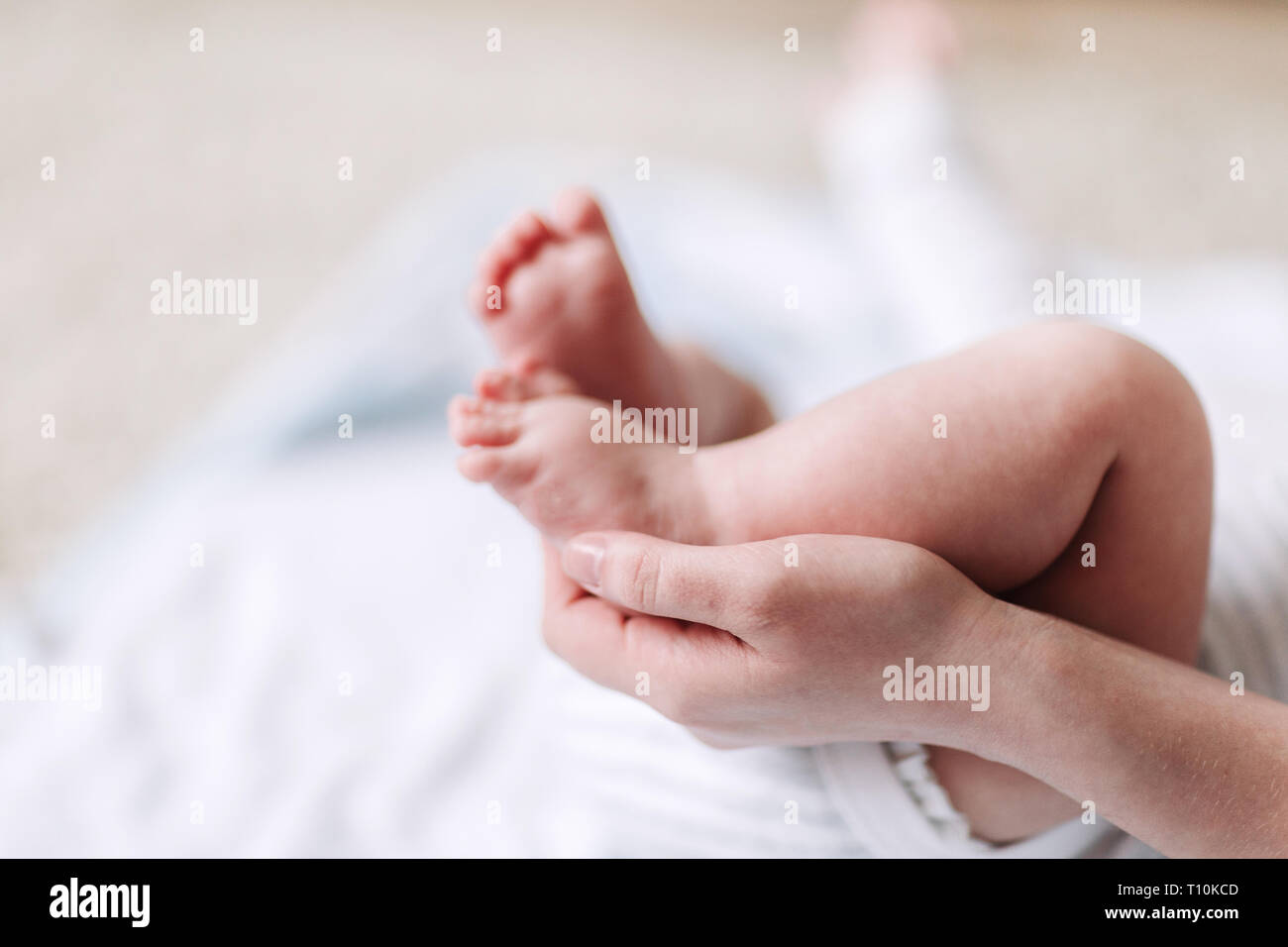 La Mere Les Mains Soigneusement Garder Le Bebe Avec Tendresse Le Pied Photo Stock Alamy