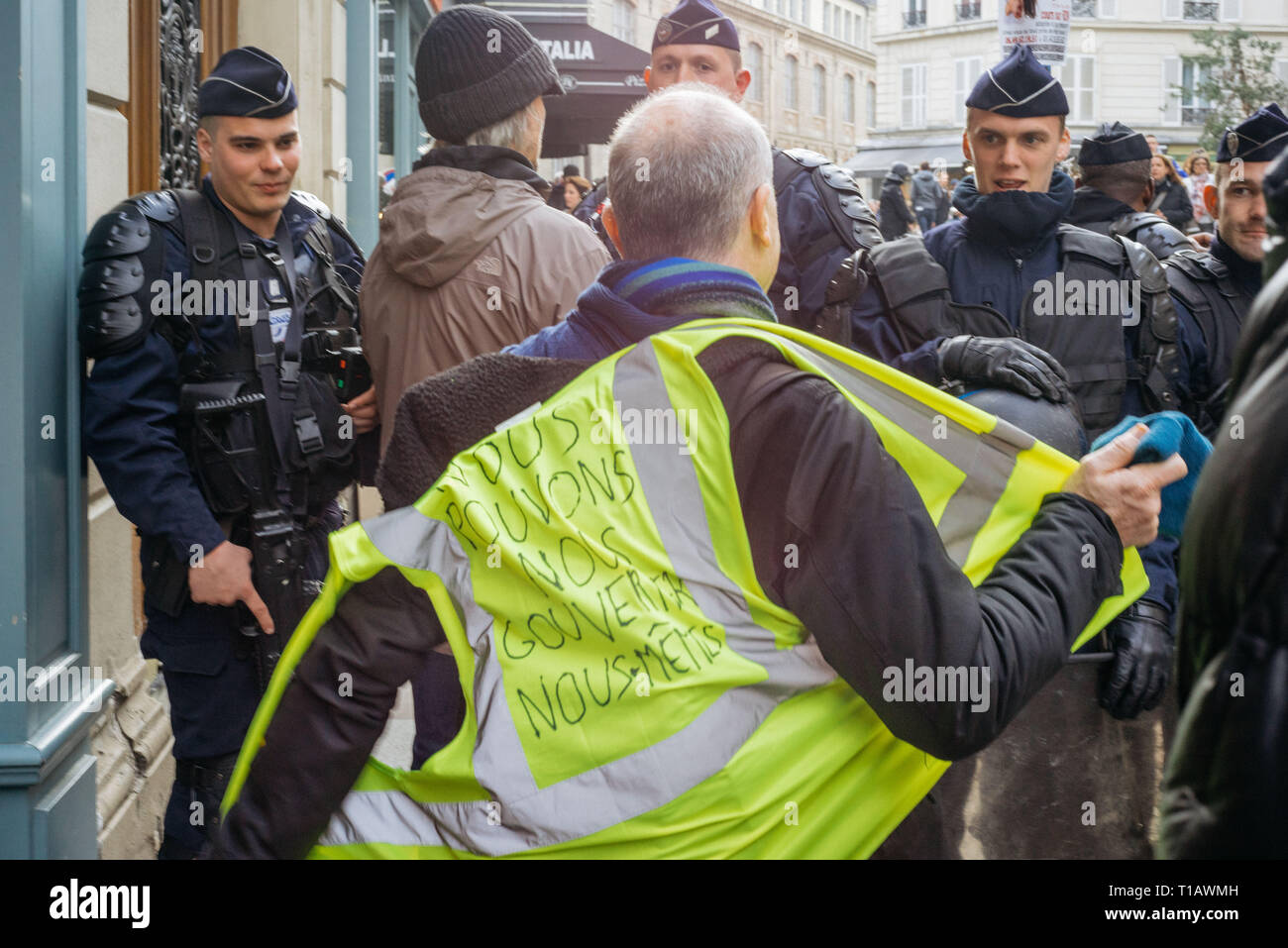 Paris, Ile de france, France. Mar 23, 2019. Un manifestant l'ôter son gilet jaune avant de franchir la barrière de la police anti-émeute à Montmartre, quartier du nord de Paris. Au cours de la XIX Loi du gilet jaune, mouvement français manifestants se rassemblent à l'instar de basilic Sacré-Cœur, au nord de Paris. Credit : Joao Victor Novelleto/SOPA Images/ZUMA/Alamy Fil Live News Banque D'Images