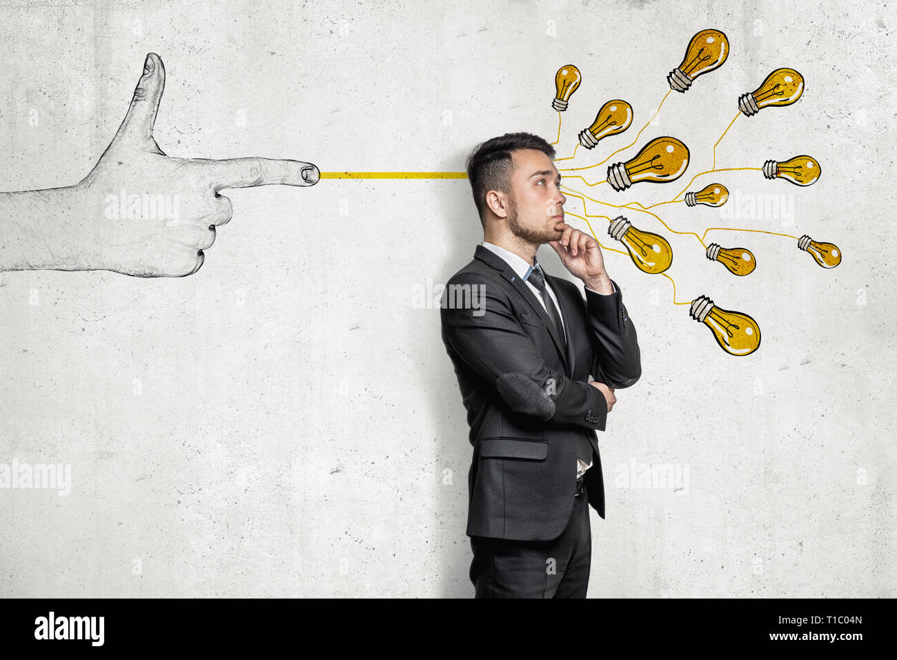 Homme d'affaires en demi-tour, main sur le menton, debout près de mur avec à la main le tir au pistolet à doigt bande d'ampoules jaunes electirc à lui. Banque D'Images