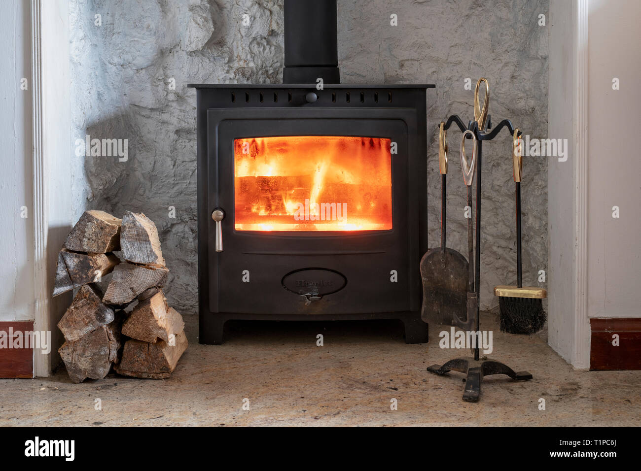 La combustion du bois dans un poêle à bois avec une pile de journaux. L'Ecosse Banque D'Images