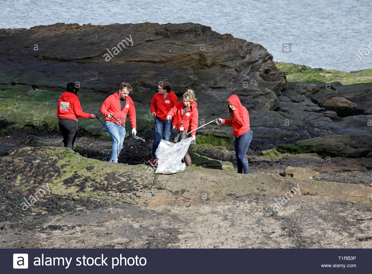 South Queensferry, Ecosse, Royaume-Uni. 28 mars 2019. People's Postcode Lottery charity de nettoyage de la plage, des bénévoles de la litière ramasser à South Queensferry Crédit du littoral : Craig Brown/Alamy Live News Banque D'Images
