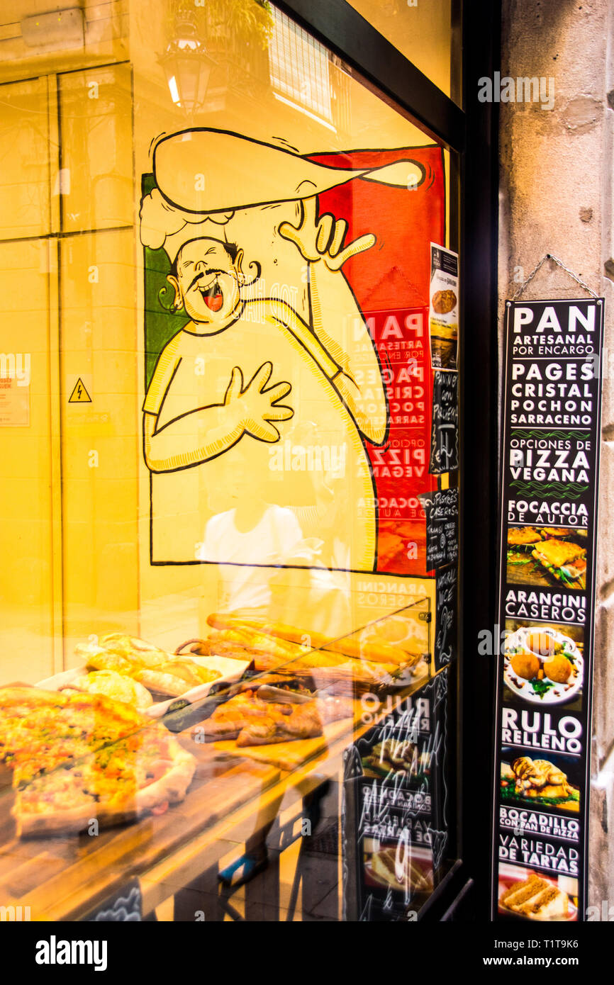 Un salon de pizza store front, Barcelone, Espagne. Banque D'Images