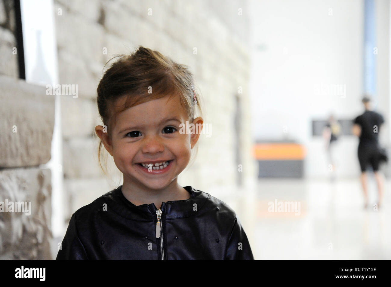 Peu Belle Blonde Girl Smiling Faces Pose Libre La Petite Fille Porte Une Veste En Cuir Bleu A L Interieur Photo Stock Alamy