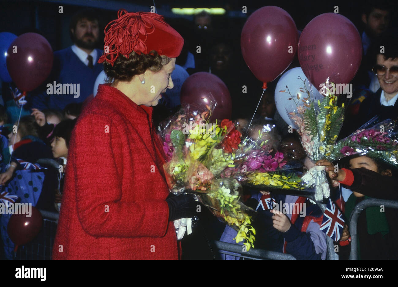 Sa Majesté la Reine Elizabeth II sur une visite royale au Queen Mary College entouré d'enfants heureux et excité. Londres. L'Angleterre. UK. Circa 1980 'SI Banque D'Images