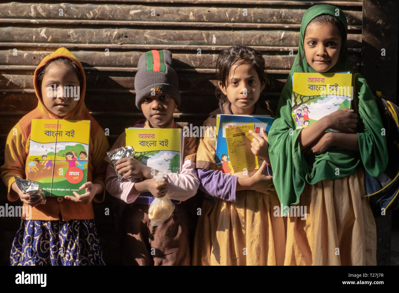 Les élèves sont de retour à l'accueil et montrer leurs livres scolaires. Ils vivent à Genève Camp, brin enclave des Pakistanais à Dhaka, au Bangladesh. Banque D'Images