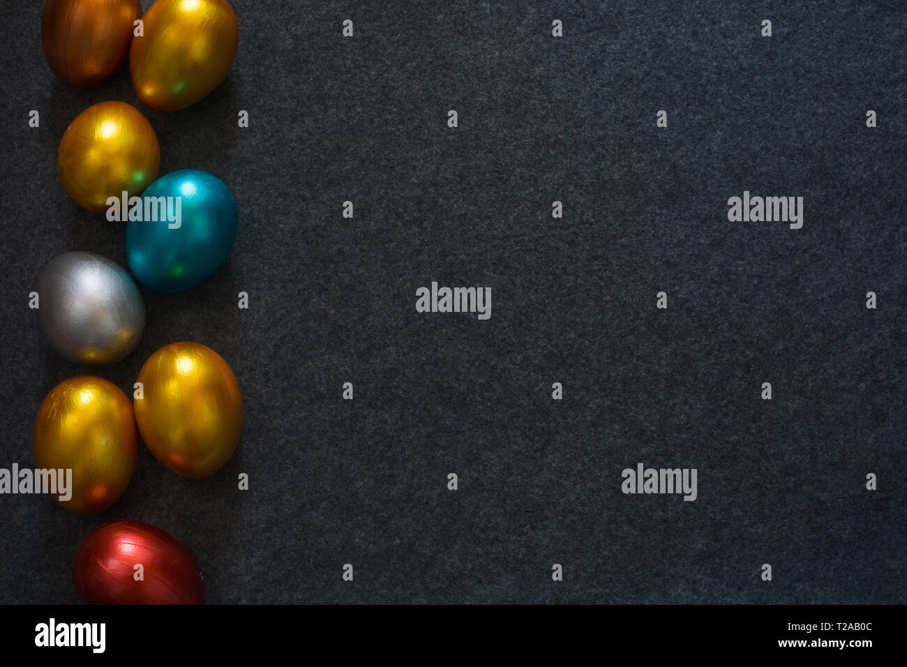 Élégant mode arrière-plan avec border frame de couleur de décoration des oeufs de Pâques métallique sur fond textile, copie espace pour le texte. Vue supérieure mise à plat Banque D'Images