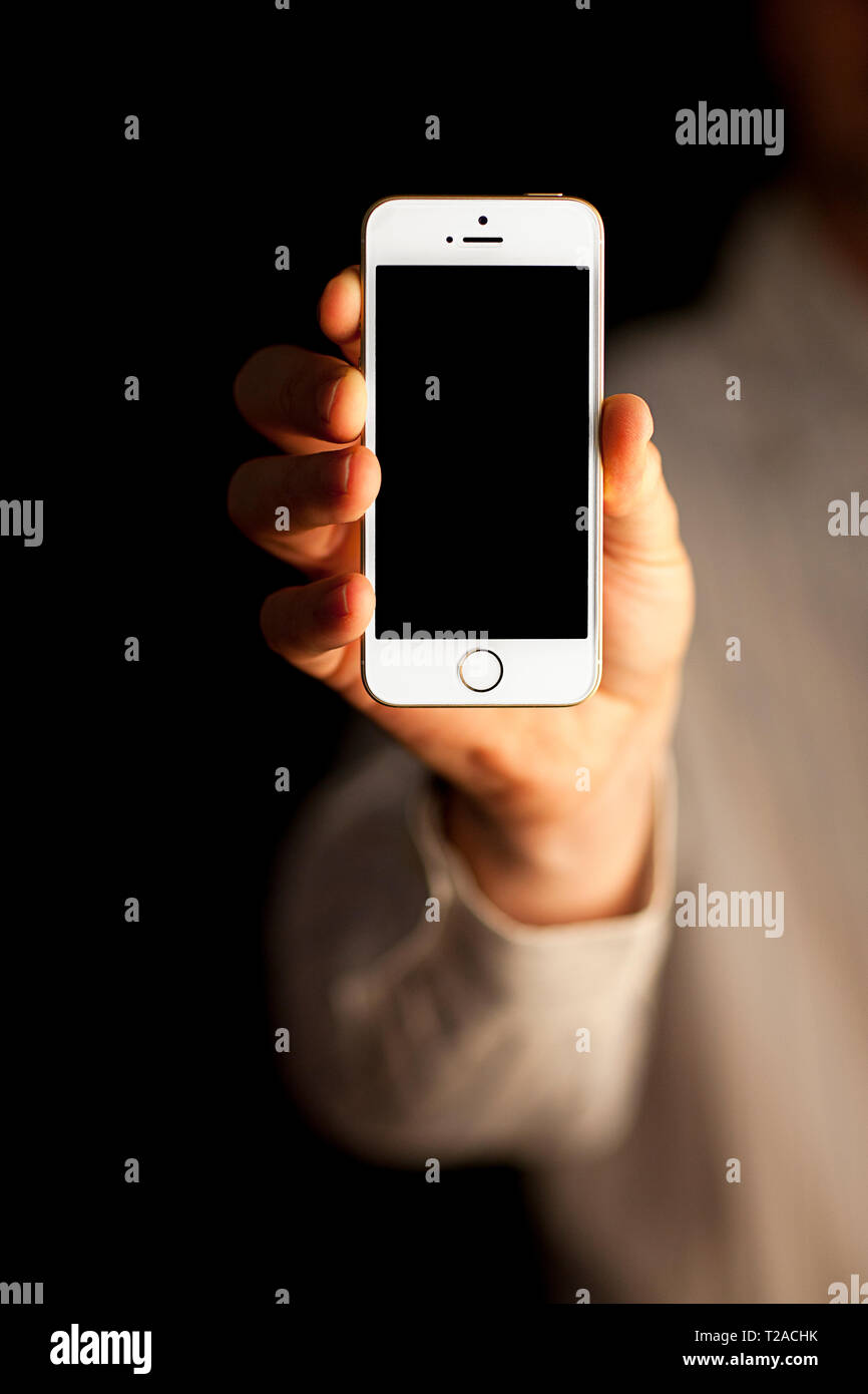 Tenir la main de l'iPhone Banque D'Images