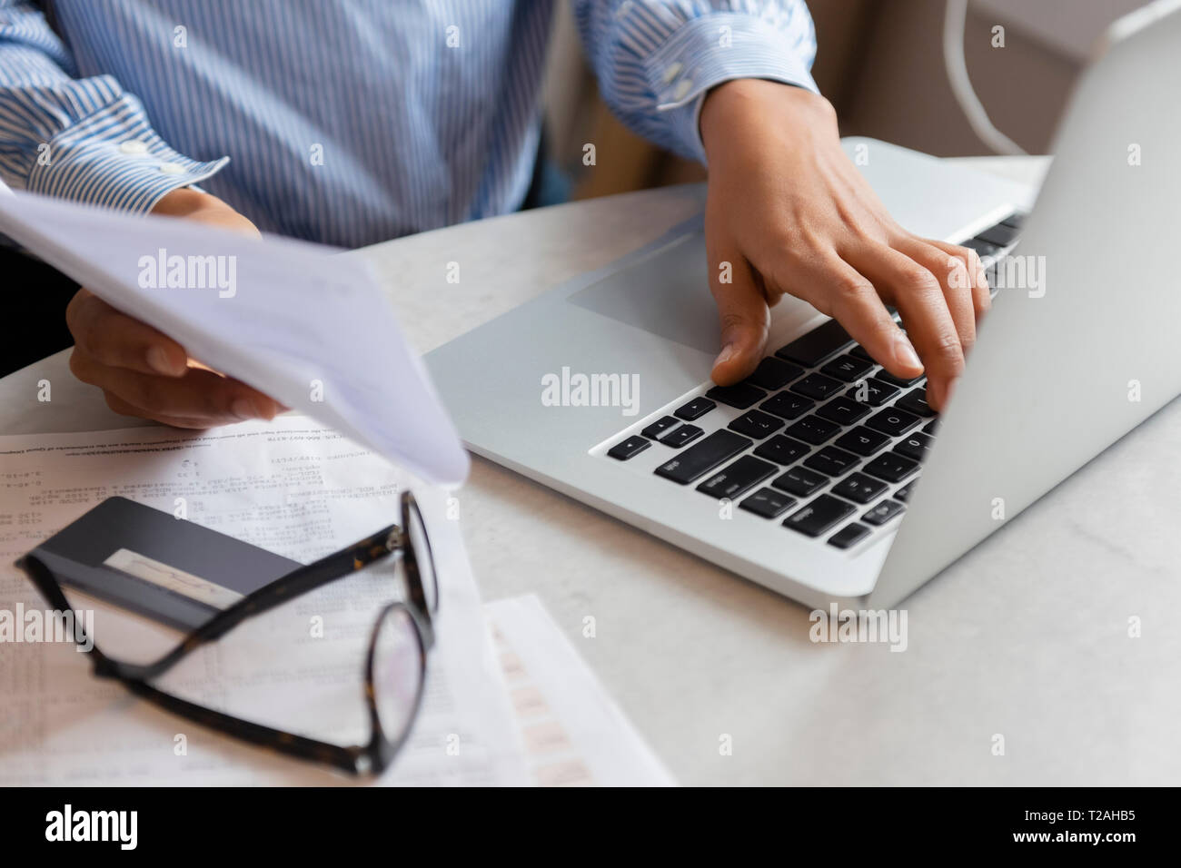 Mains de woman typing on laptop Banque D'Images