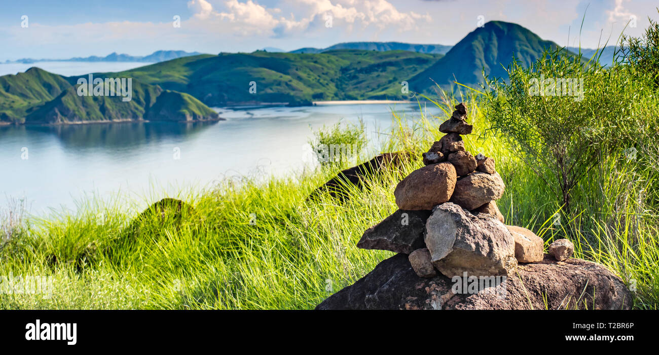 La tour de pierres, rock sculpture zen dans le paysage naturel et l'harmonie de vertes collines de Padar Island dans le Parc National de Komodo. Banque D'Images La tour de pierres, rock sculpture zen dans le paysage naturel et l'harmonie de vertes collines de Padar Island dans le Parc National de Komodo. Banque D'Images