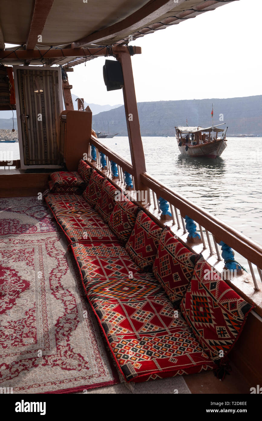 Bateau de croisière à bord d'un boutre arabe décoration traditionnelle bateau en bois le long des montagnes rocheuses de la péninsule de Musandam dans l'Oman Fjords Banque D'Images