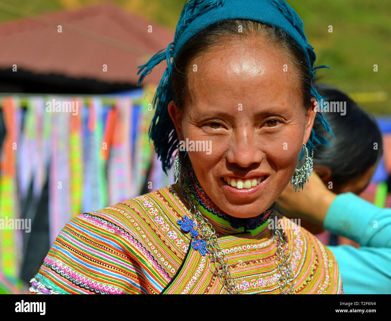 Vietnamien à maturité des H'Mong femme porte une fleur colorés traditionnels vêtements H'Mong et sourit pour la photo. Banque D'Images