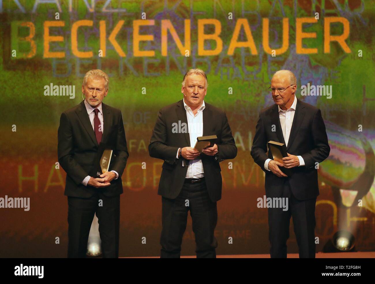 Football : DFM firo musée du football allemand Hall of Fame 01.04.2019 Ouverture de la HALL OF FAME le 1er avril à Dortmund Le plus grand joueur de tous les temps sur une scène, de la défense. De gauche à droite : Paul Breitner, Andreas Brehme et Franz Beckenbauer | conditions dans le monde entier Banque D'Images