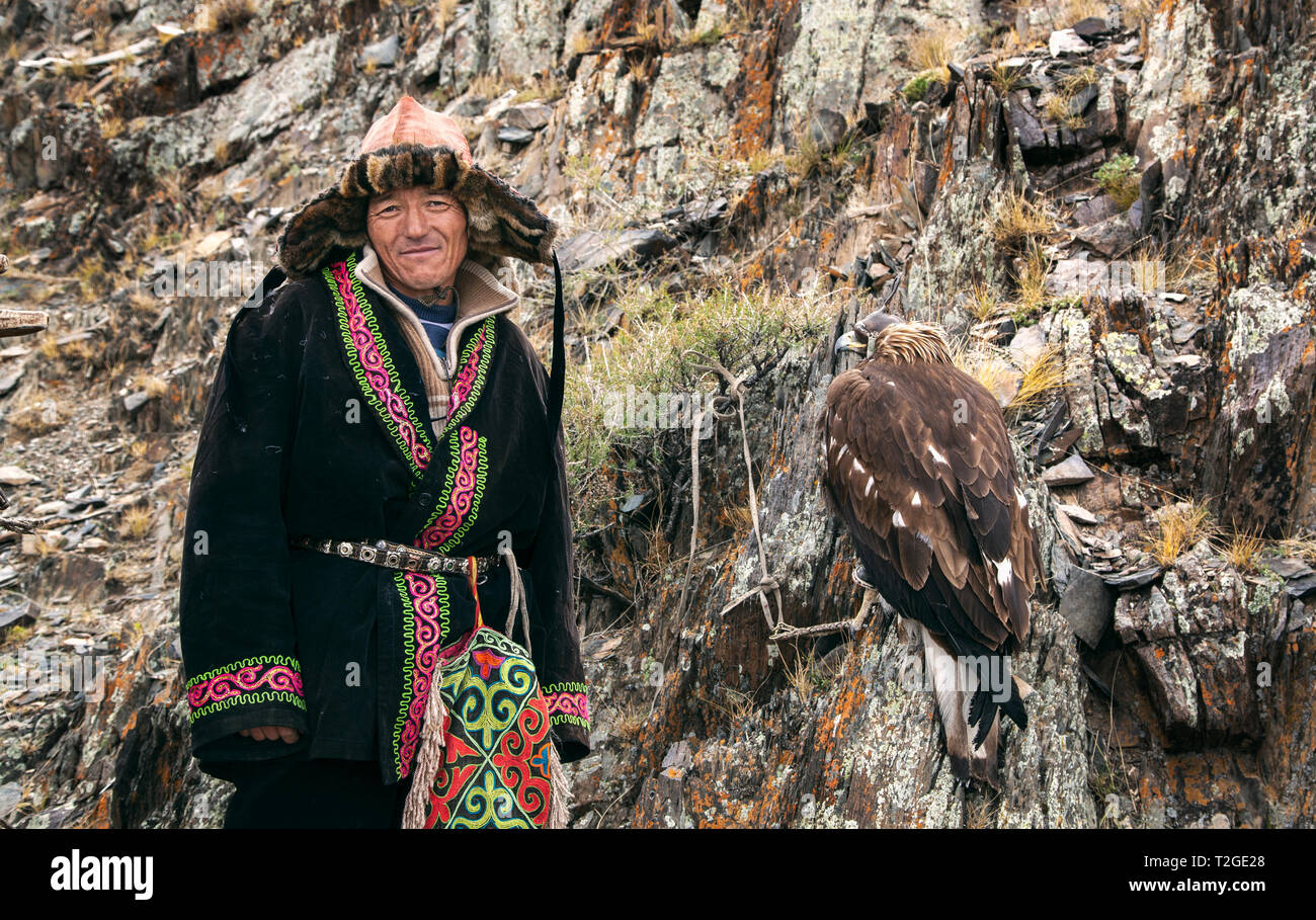 Bayan Ulgii, Mongolie, 3 octobre 2015 : kazakh eagle hunter avec son aigle au repos dans les montagnes Banque D'Images