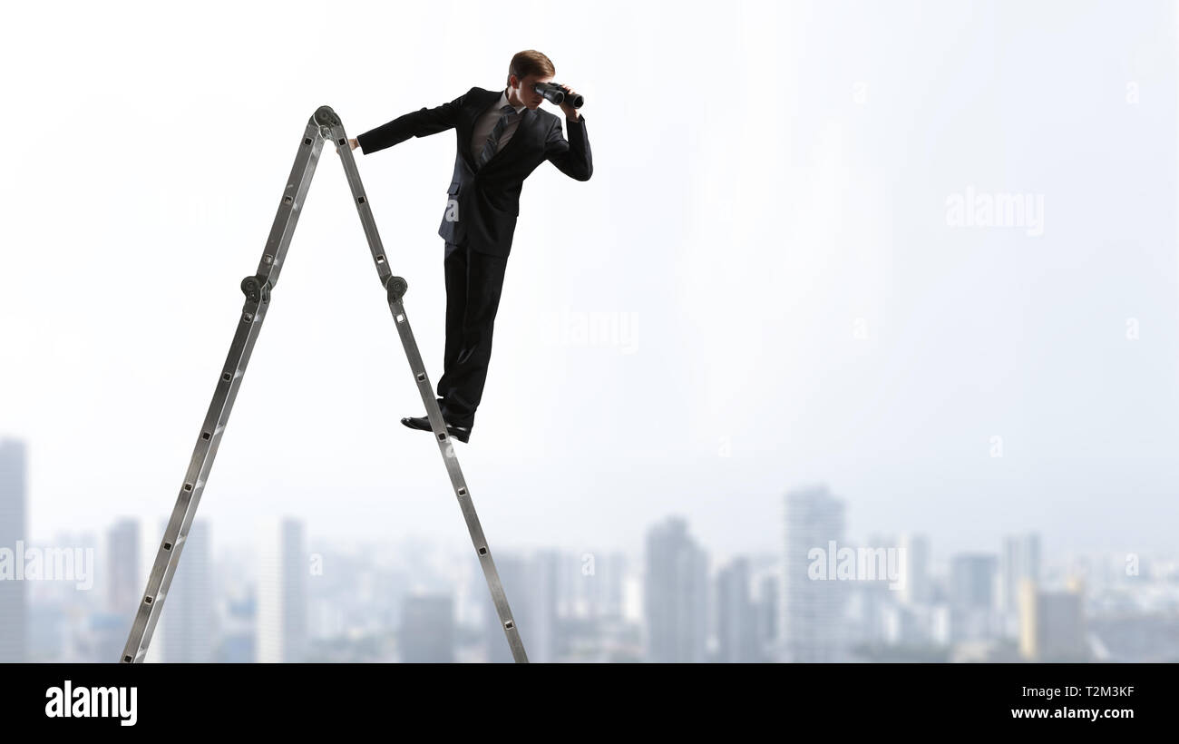 Businessman standing et regardant dans des jumelles. Technique mixte Banque D'Images