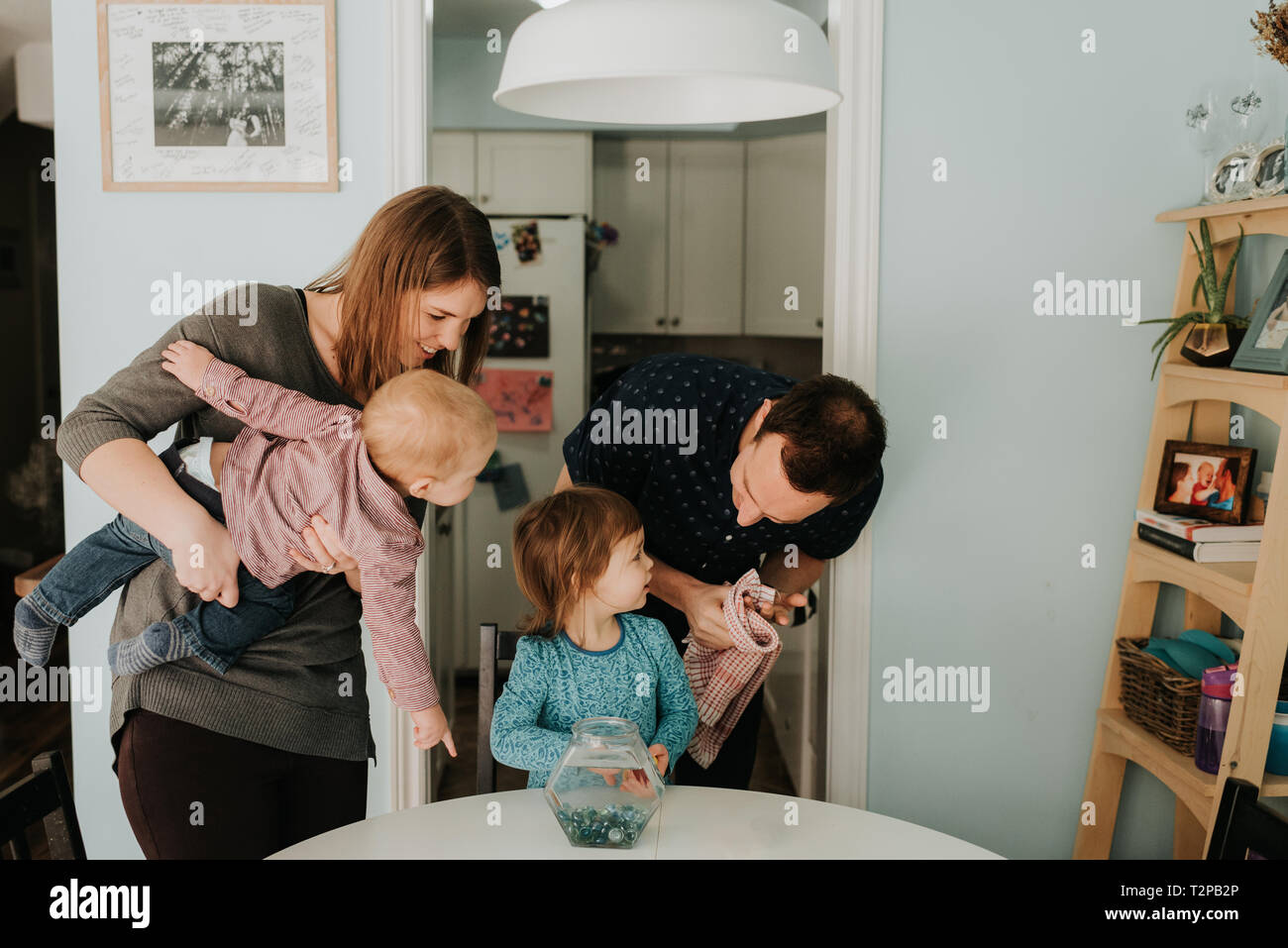 Young couple at table with female Toddler and baby son Banque D'Images