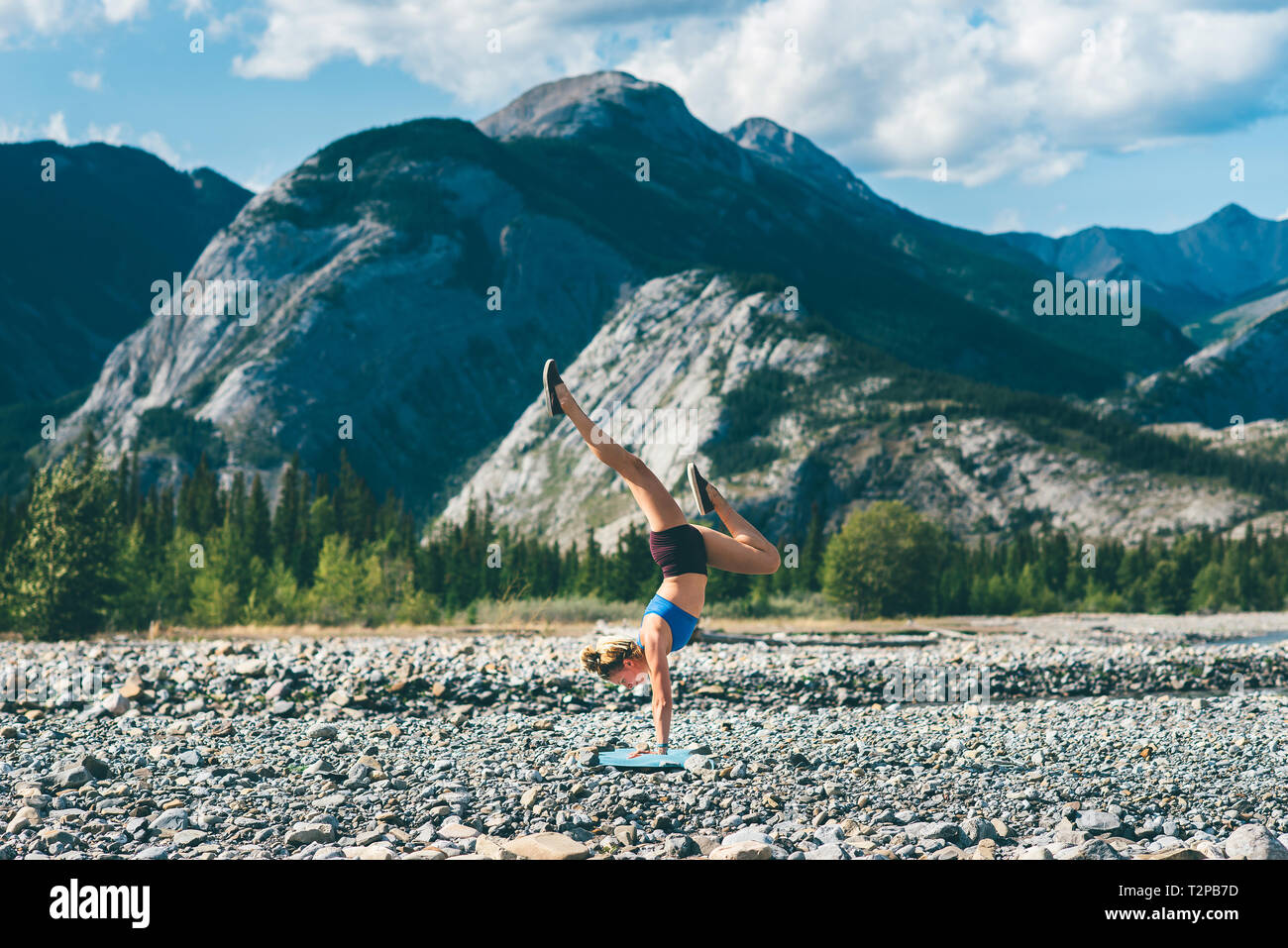 Woman doing handstand sur domaine de pierres, Jasper, Canada Banque D'Images