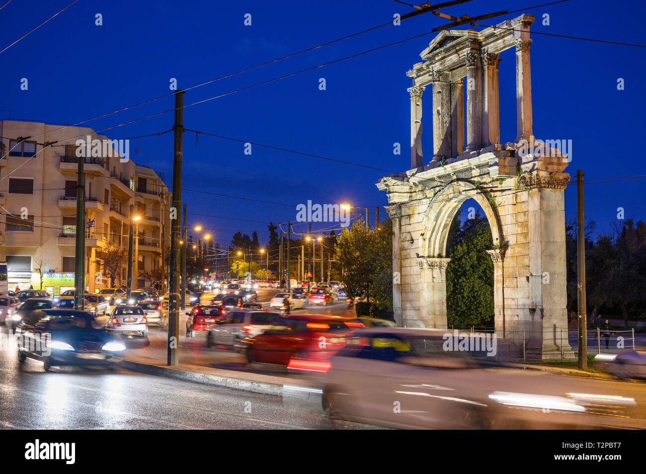 Le trafic lourd en passant l'Arche d'Hadrien sur Leoforos Vasilisis Amalias la nuit, le Centre d'Athènes, Grèce. Banque D'Images