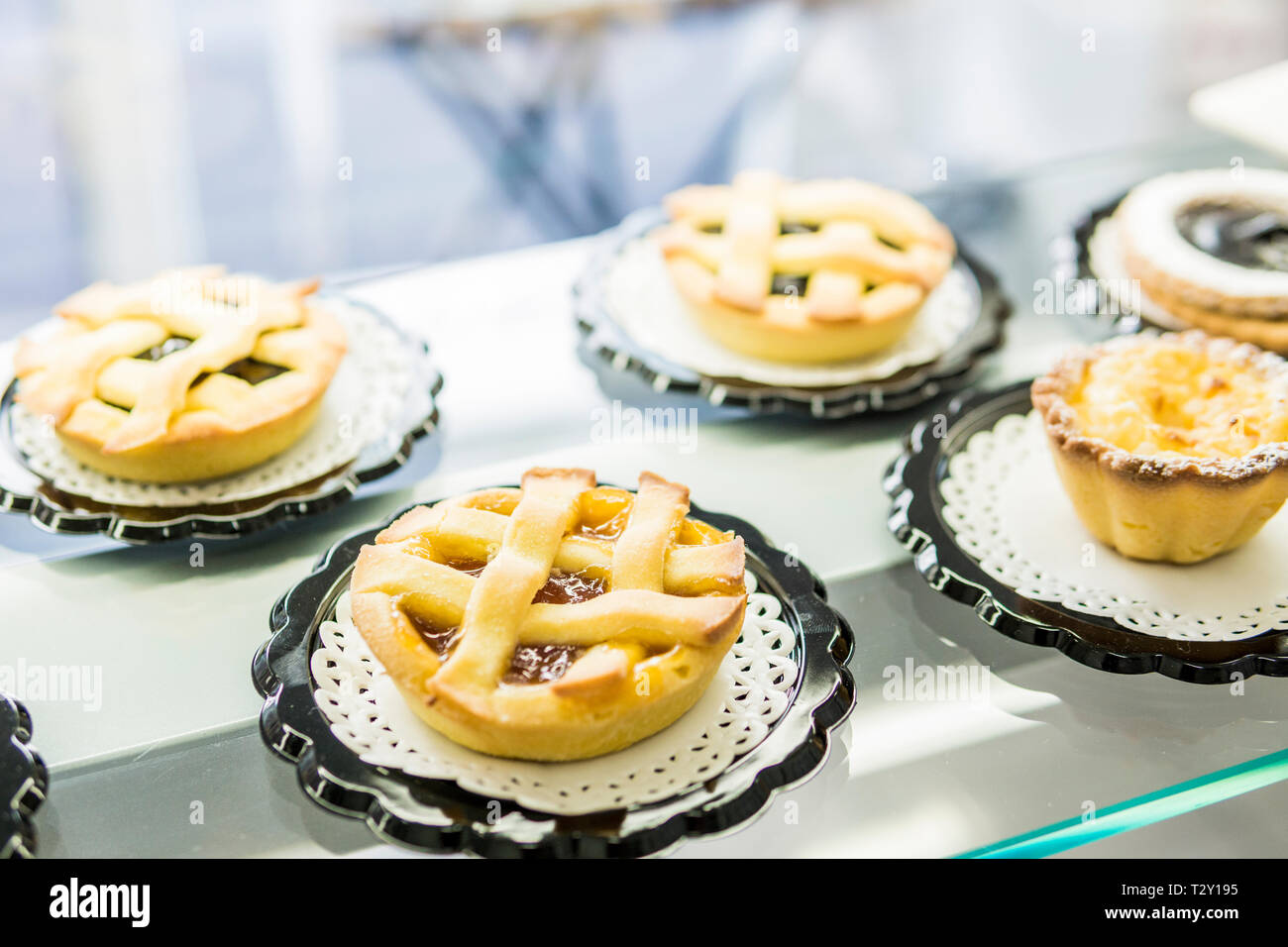 Tartelettes à la confiture et des puddings de riz sur la vitrine d'une pâtisserie Banque D'Images