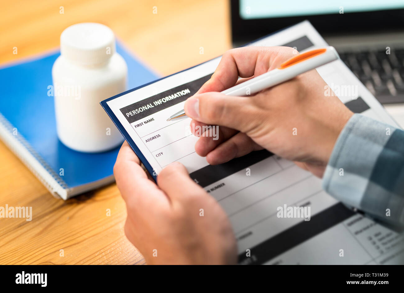 Homme remplissant le formulaire médical pour l'assurance maladie. Recherche, enquête ou étude en médecine. Le patient ou le médecin écrivant des informations personnelles et des données médicales. Banque D'Images