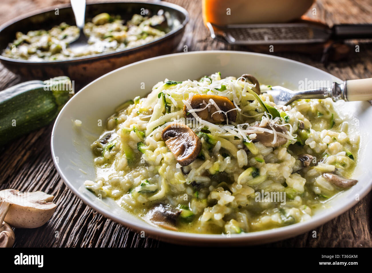 Risotto aux champignons courgettes italienne et le parmesan en plaque blanche. Banque D'Images
