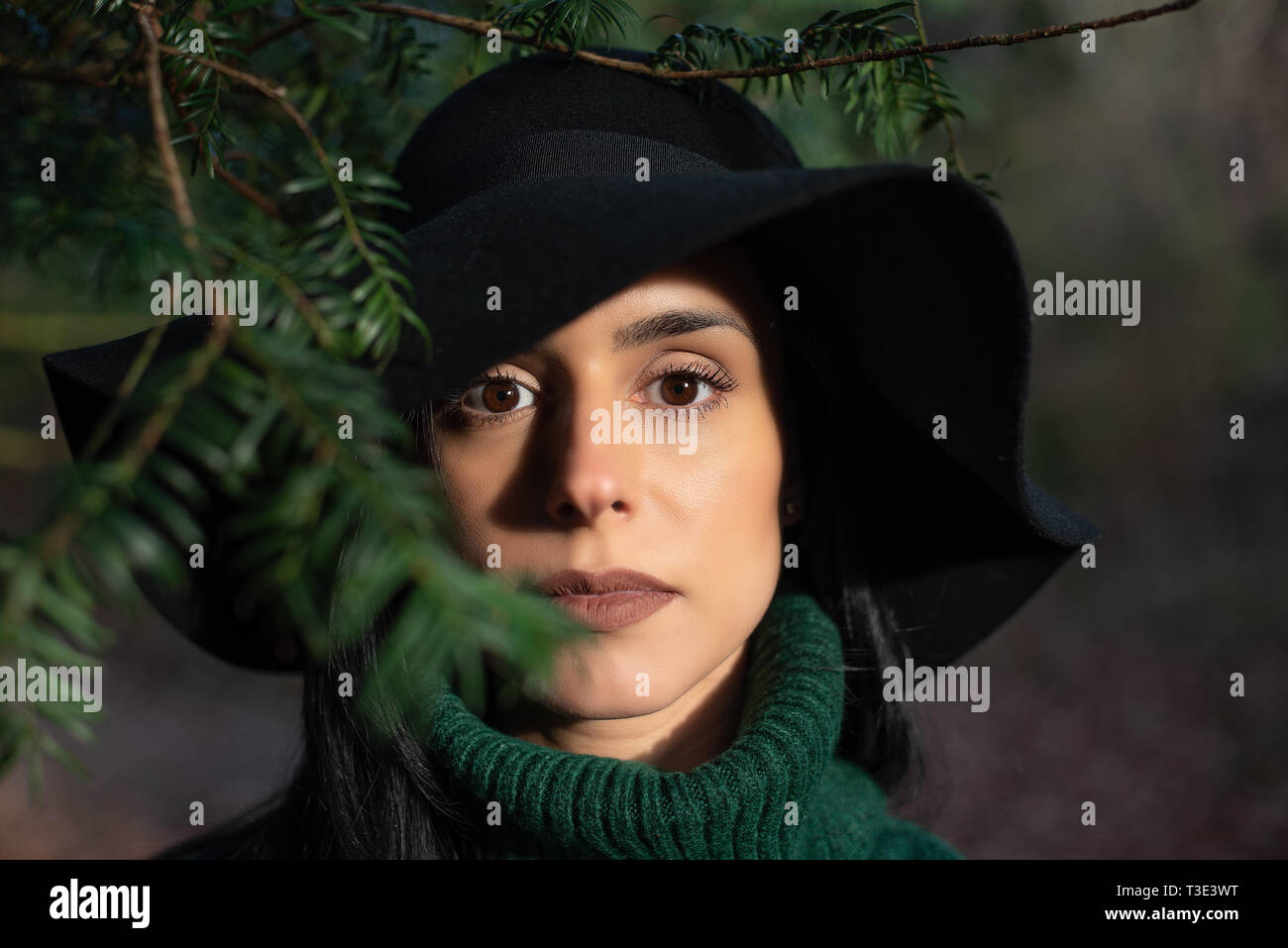 Piscine, closeup portrait d'une femme aux cheveux noirs portant un chapeau Banque D'Images