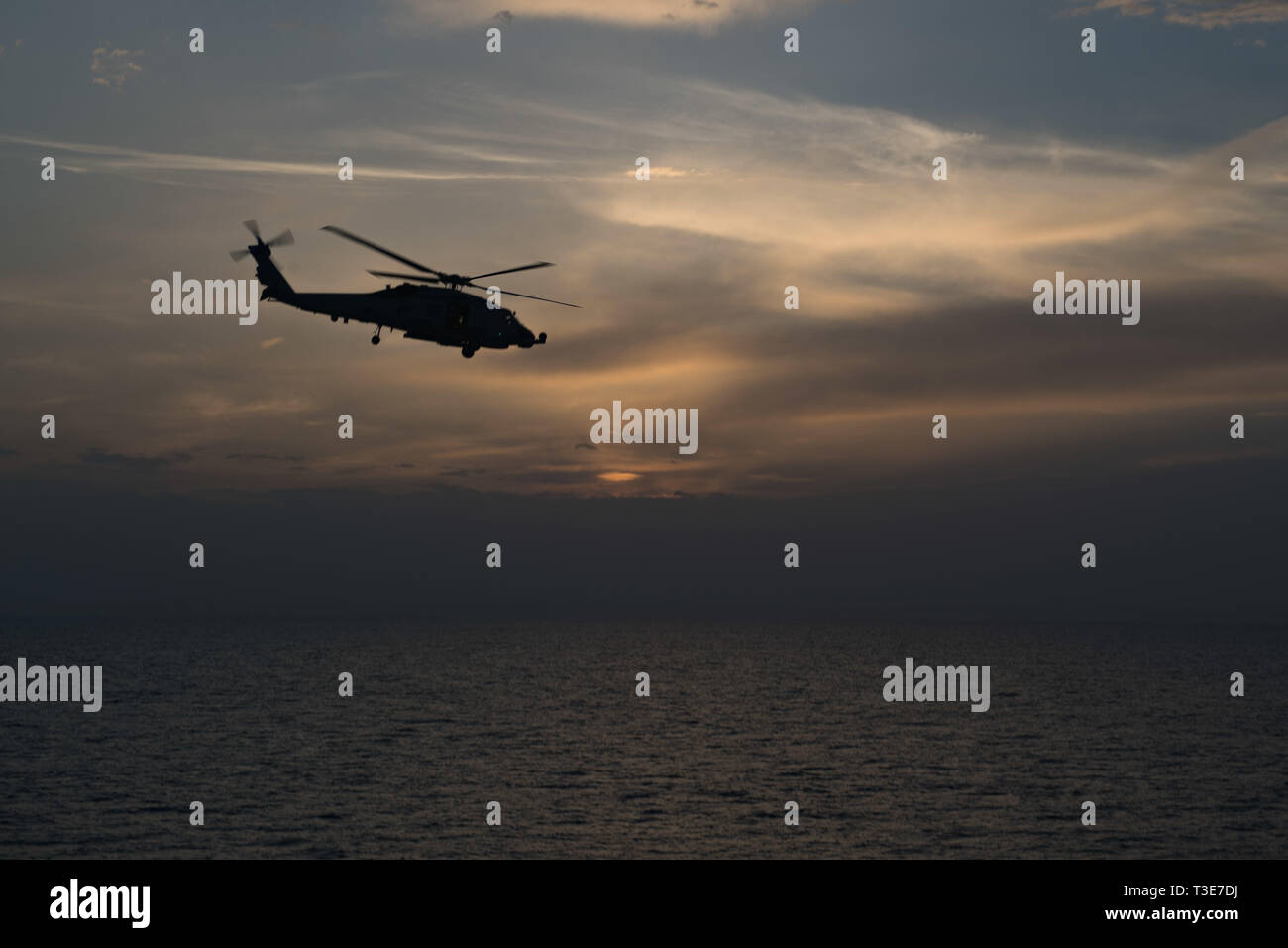 MH-60R Un hélicoptère Sea Hawk, affecté à l'Escadron d'hélicoptères grève maritime (HSM) 71, les mouches sur le détroit d'Ormuz après le lancement de missiles de l'USS Stockdale (DDG 106), le 3 avril 2019. L'Stockdale est déployé sur le 5e flotte américaine zone d'opérations à l'appui des opérations navales pour assurer la stabilité et la sécurité maritime dans la région Centrale, reliant la Méditerranée et le Pacifique à travers l'ouest de l'Océan indien et trois points d'étranglement stratégiques. (U.S. Photo par marine Spécialiste de la communication de masse 2e classe Abigayle Lutz) Banque D'Images