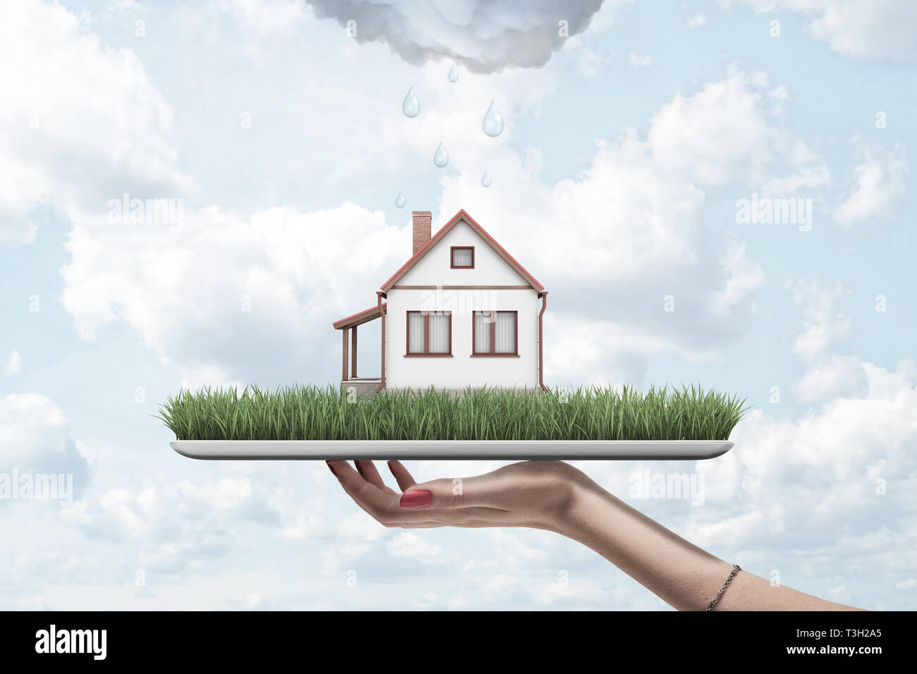 Vue latérale du woman's hand holding comprimé avec de l'herbe verte et petite maison indépendante à l'écran, avec de la pluie au-dessus des nuages. Banque D'Images