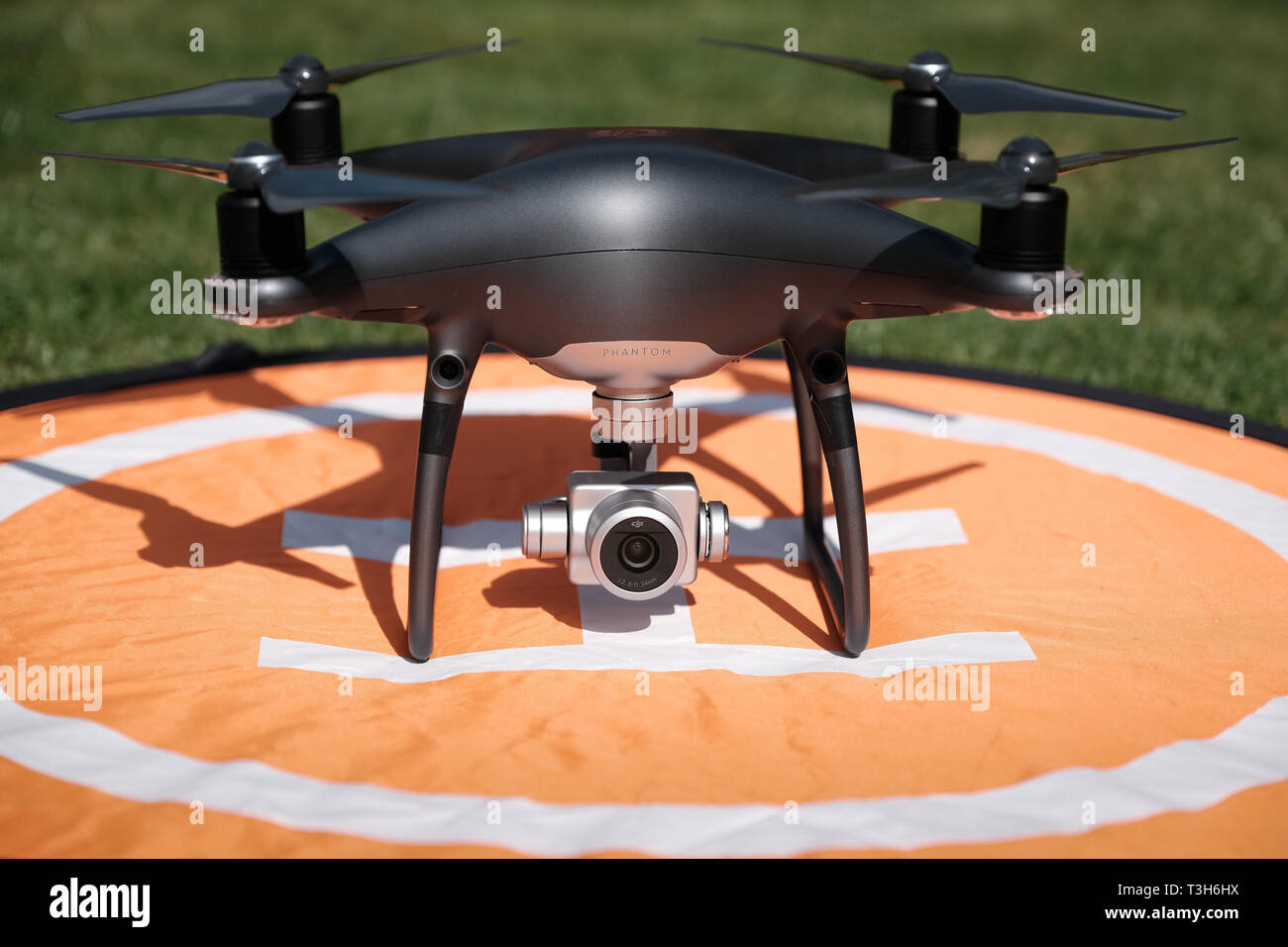 Vue de face d'un fantôme noir obsidienne Pro 4 DJI quadcopter drone sur une  plate-forme d'atterrissage orange entouré d'herbe sur une journée  ensoleillée Photo Stock - Alamy