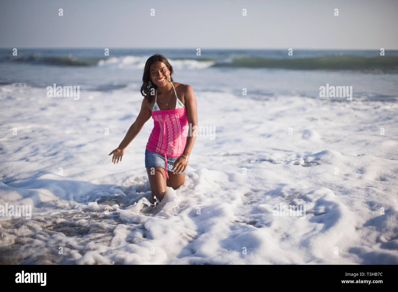 Girl genou dans l'eau, El Salvador. Banque D'Images
