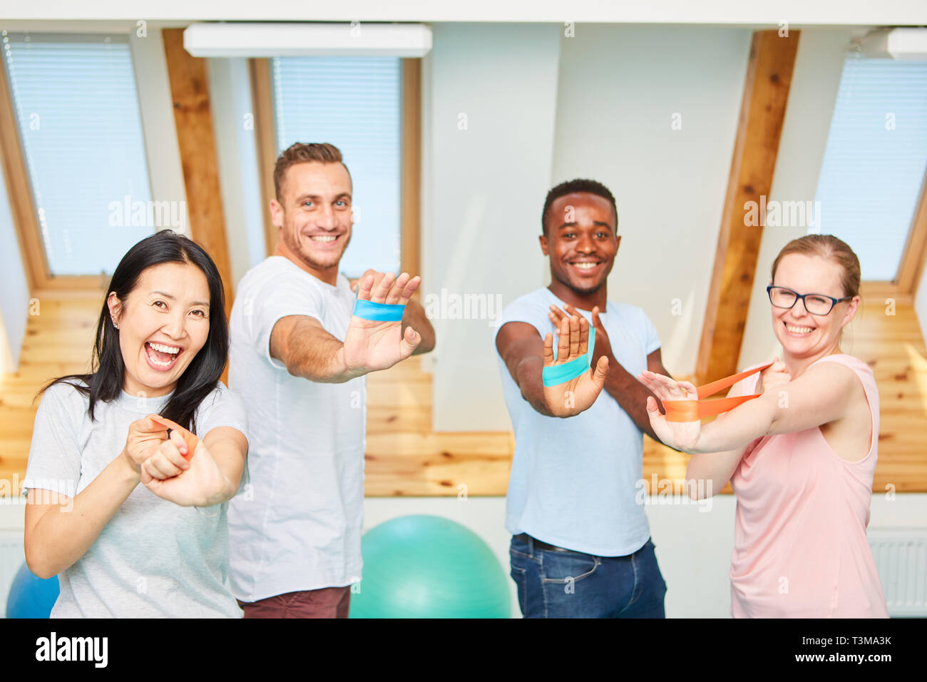 Les jeunes gens actifs faisant la formation de remise en forme avec l'exercice ou bande bande élastique Banque D'Images