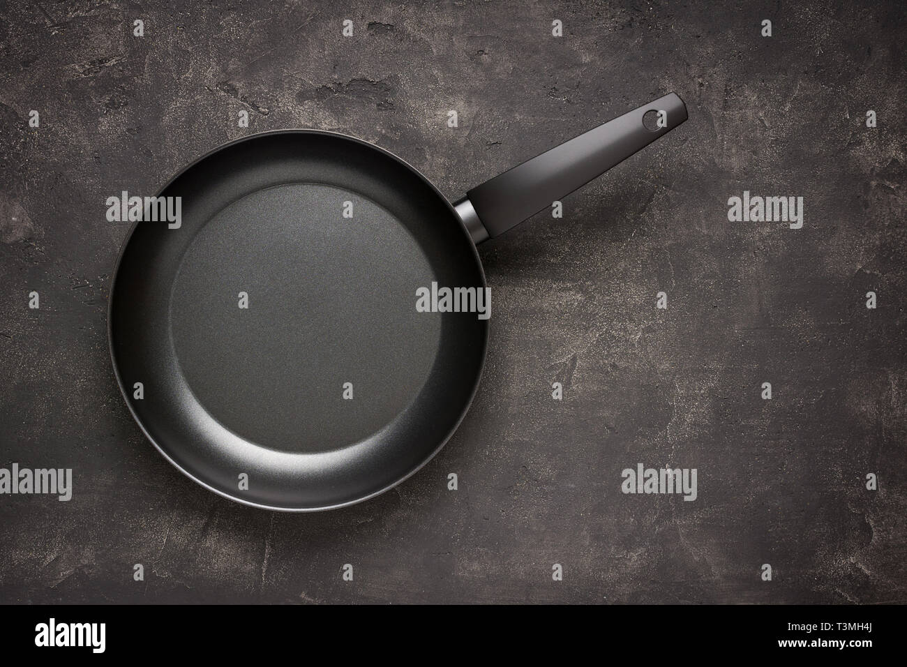 Poêle vide noir sur la surface de pierre sombre. Contexte culinaire. Banque D'Images
