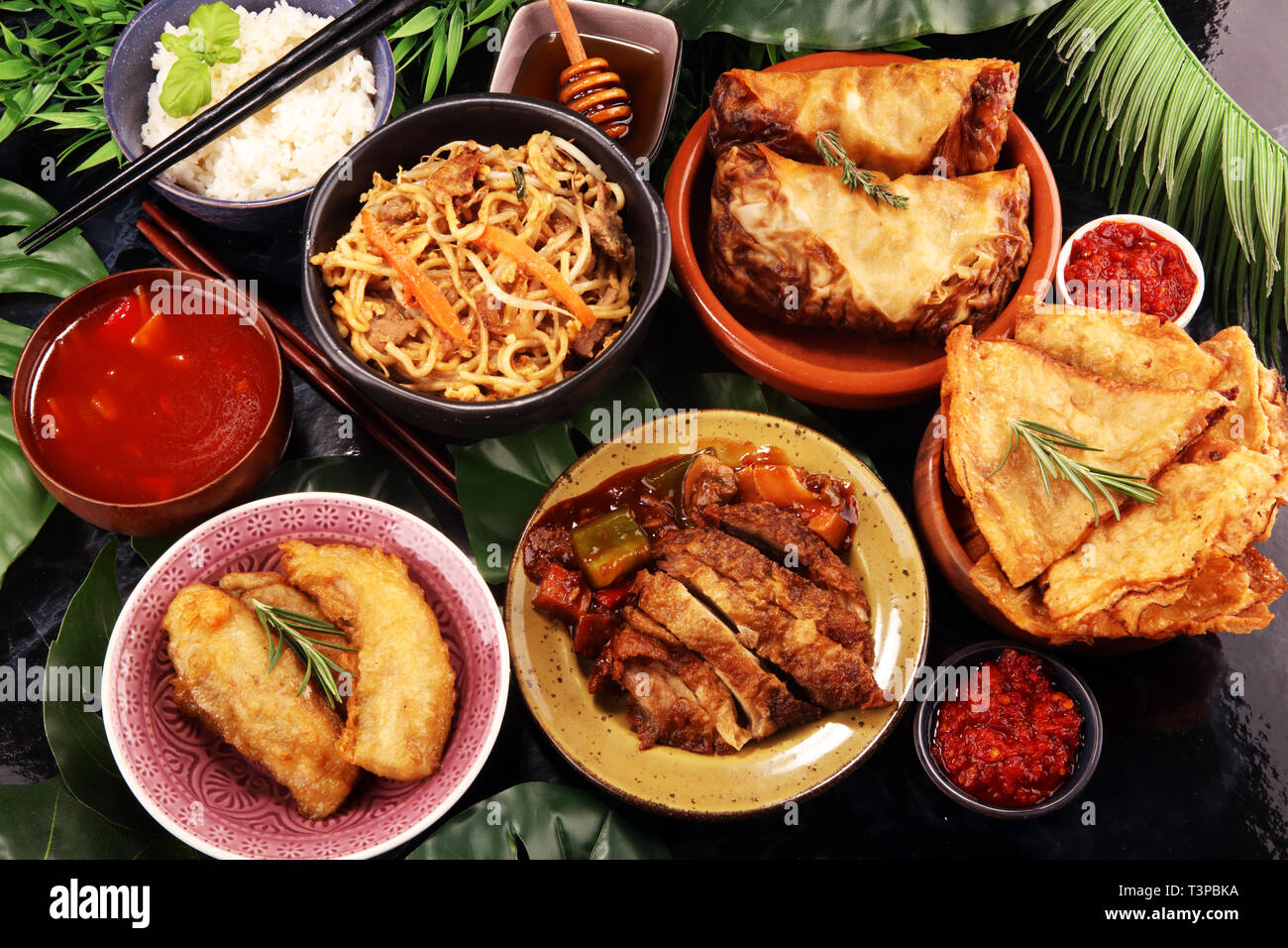 Un assortiment de plats chinois. Riz frit, nouilles chinoises, le canard de Pékin, dim sum, rouleaux de printemps. La cuisine chinoise célèbre plats sur table. Restaurant chinois Banque D'Images