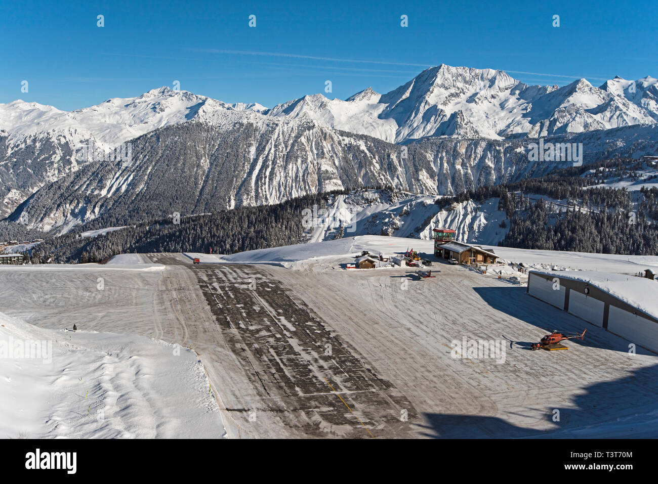 Paysage panoramique vue du petit aéroport de la piste de l'altiport sur le flanc d'une montagne des Alpes couvertes de neige en hiver Banque D'Images