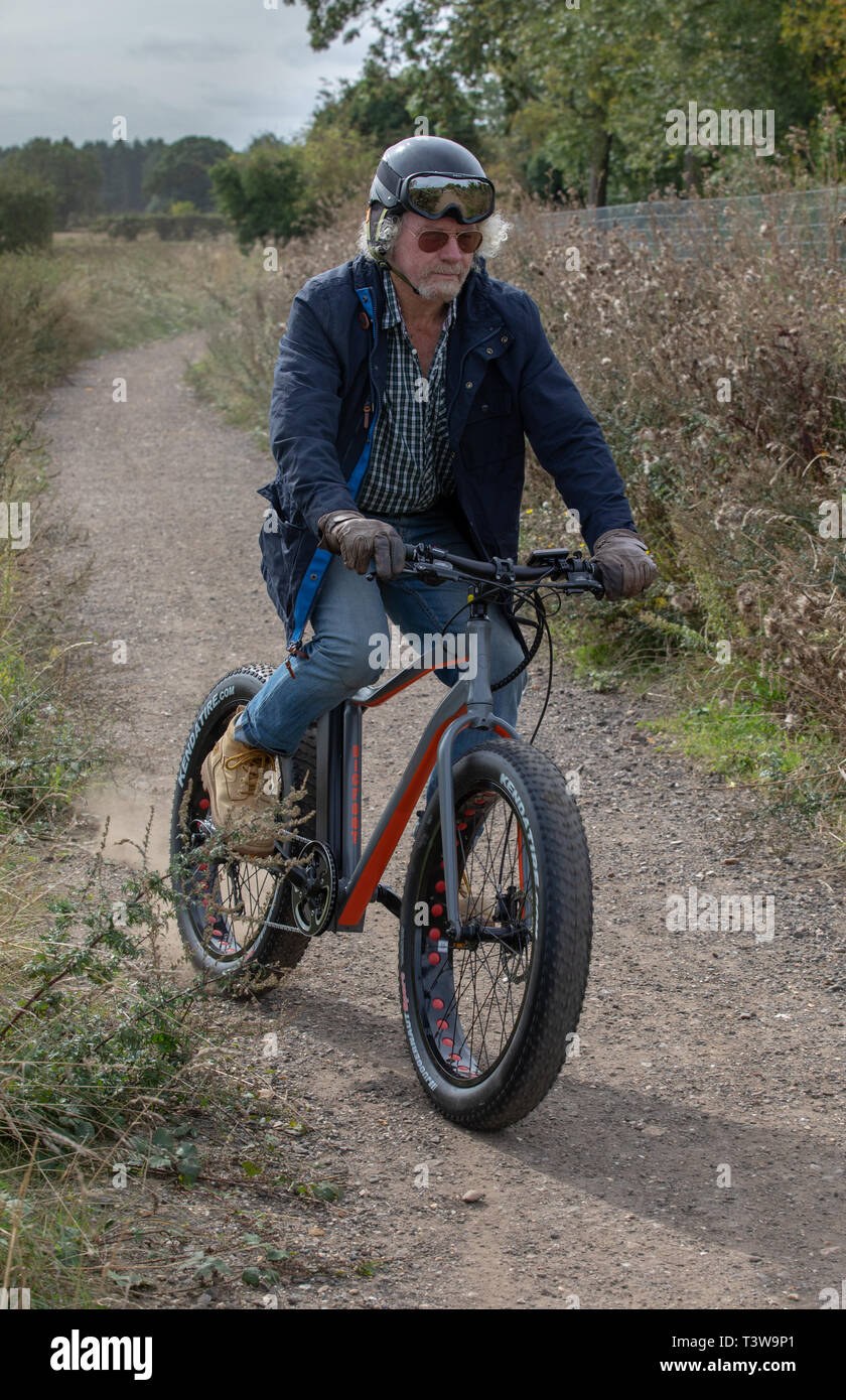 Un homme rides un vélo électrique UK Banque D'Images