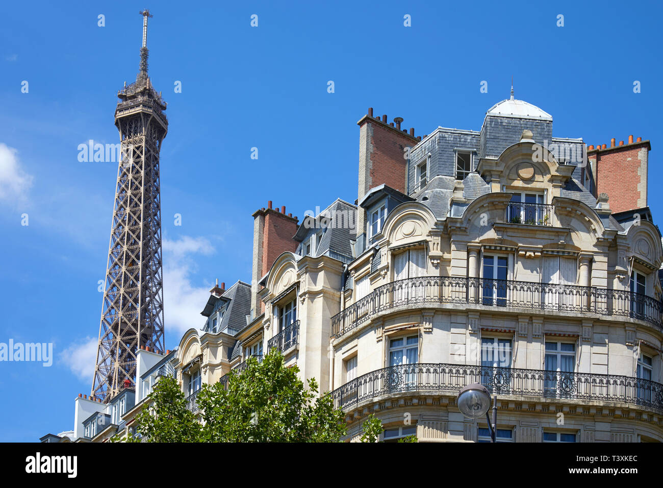 PARIS, FRANCE - 21 juillet 2017 : Tour Eiffel et haut bâtiment typique à Paris avec balcon dans un beau jour d'été, ciel bleu clair Banque D'Images