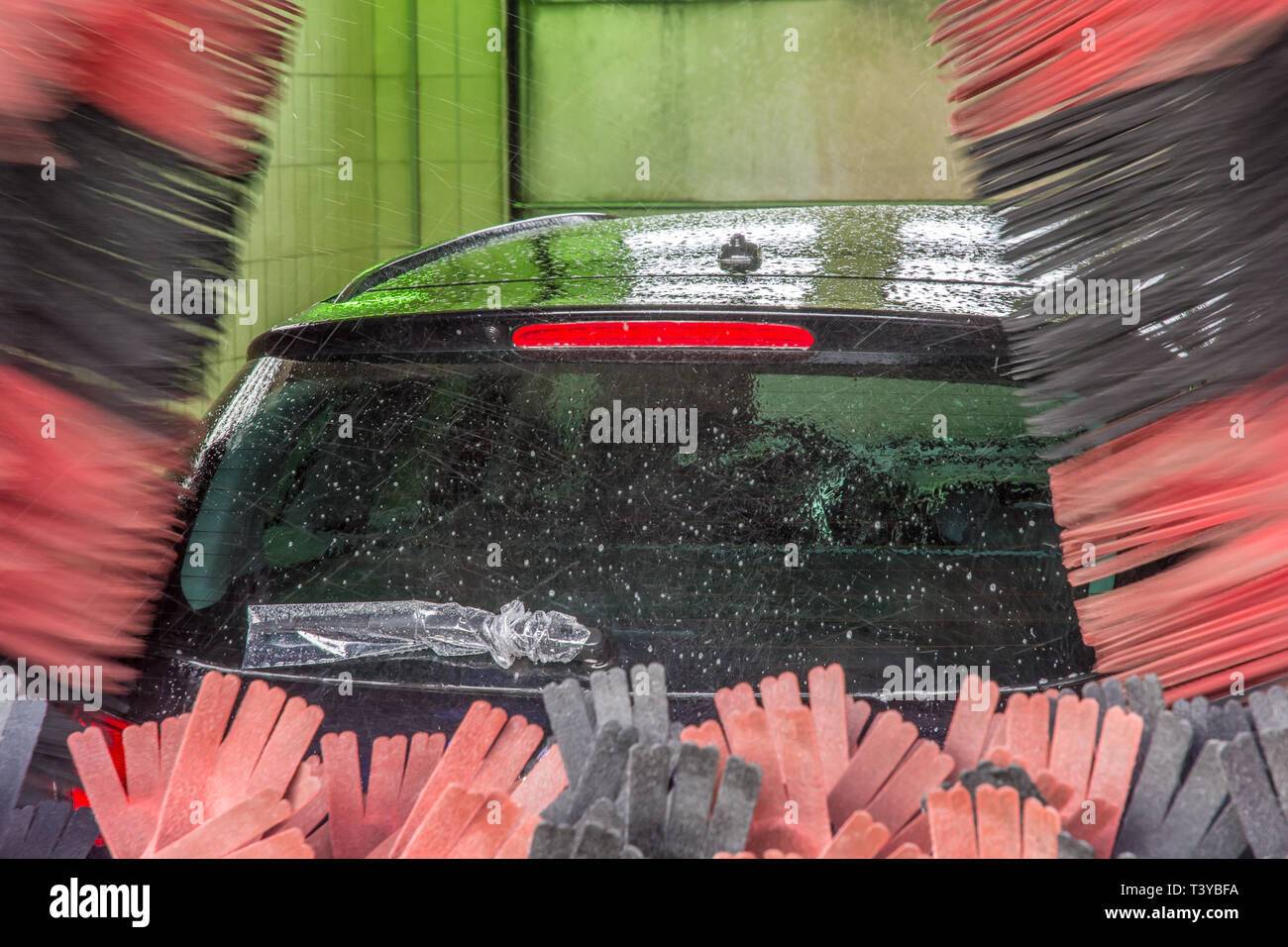 Voiture dans un lavage de voiture avec de l'essuie-glace arrière enveloppé Banque D'Images