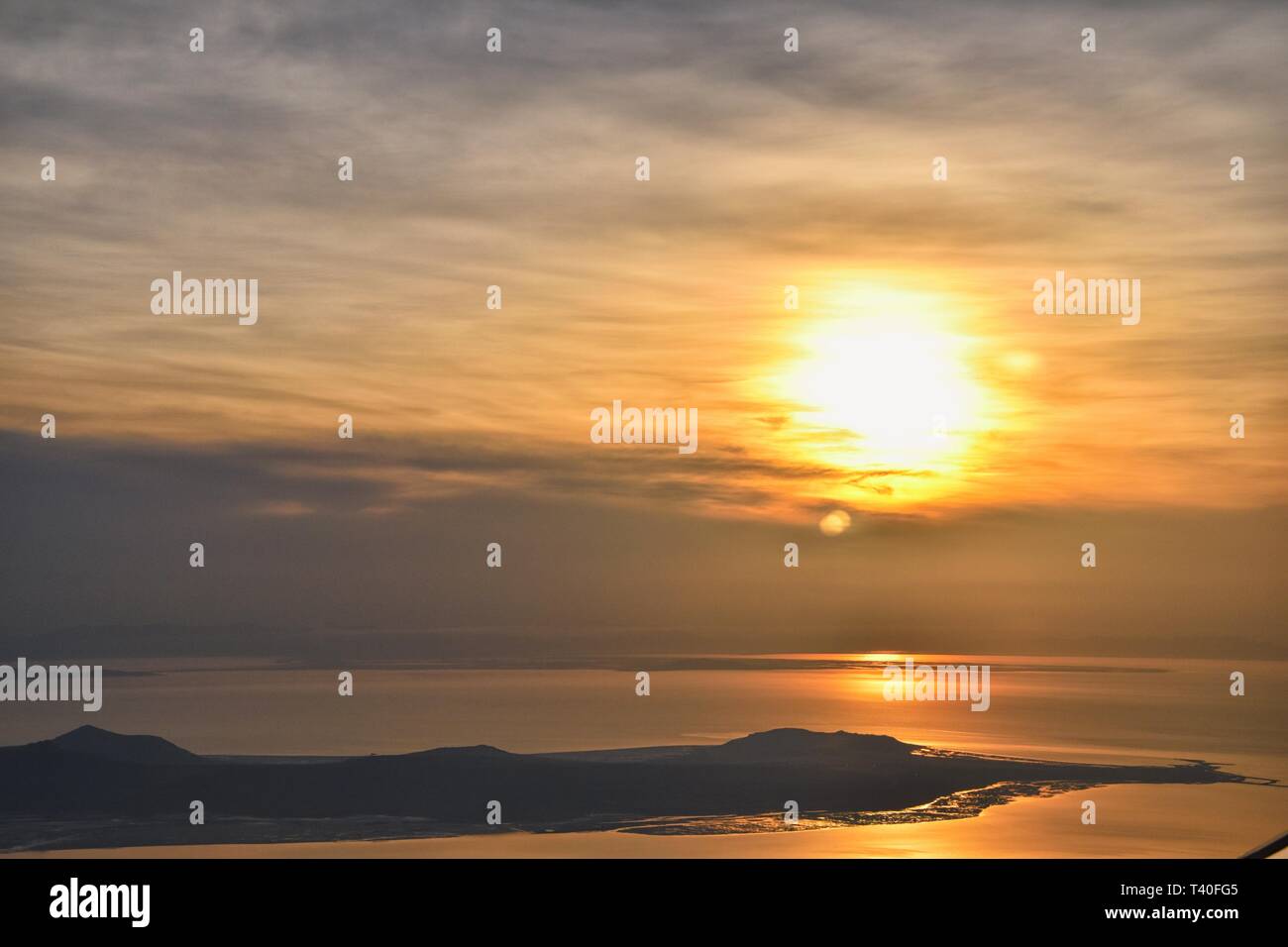 Vue aérienne de l'avion d'Antelope Island au coucher du soleil, vue de Magna, balayant cloudscape au lever du soleil avec le Great Salt Lake State Park en hiver. Banque D'Images