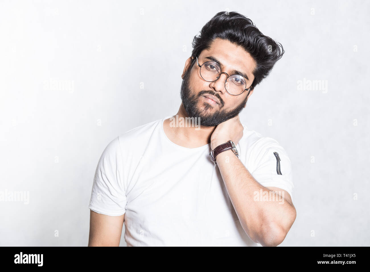 Séduisant jeune homme conserve la main sur le cou, tente de soulager la fatigue musculaire Banque D'Images