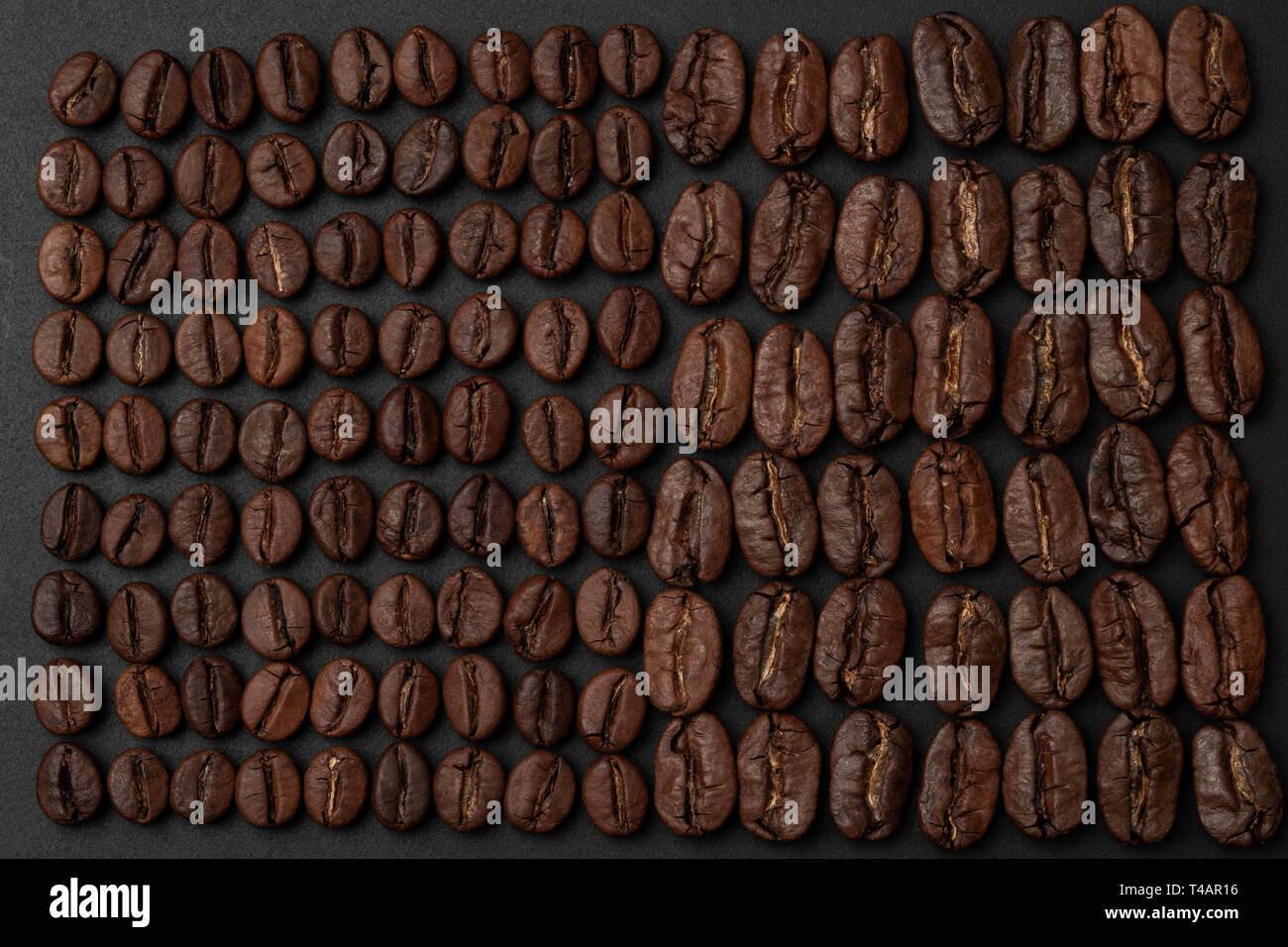 Les grains de café torréfiés sur fond noir Banque D'Images