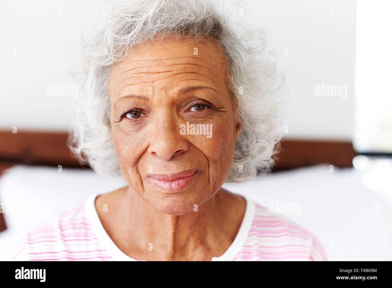 Portrait de femme déprimée à côté de malheureux Sitting on Bed At Home Banque D'Images
