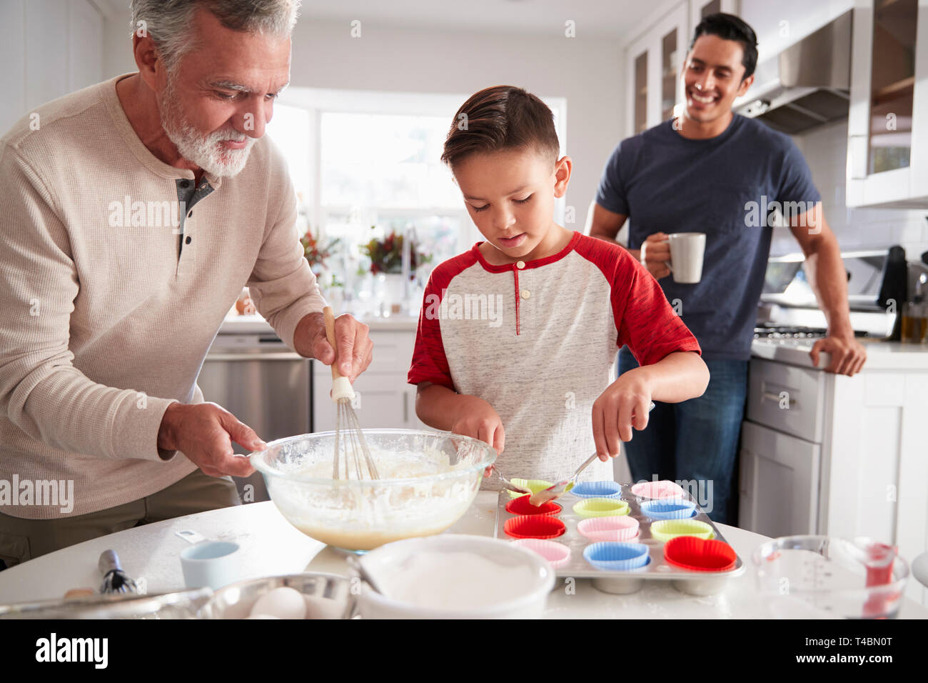 Papa en regardant son fils faire des gâteaux avec mon grand-père à la table de cuisine, Close up Banque D'Images