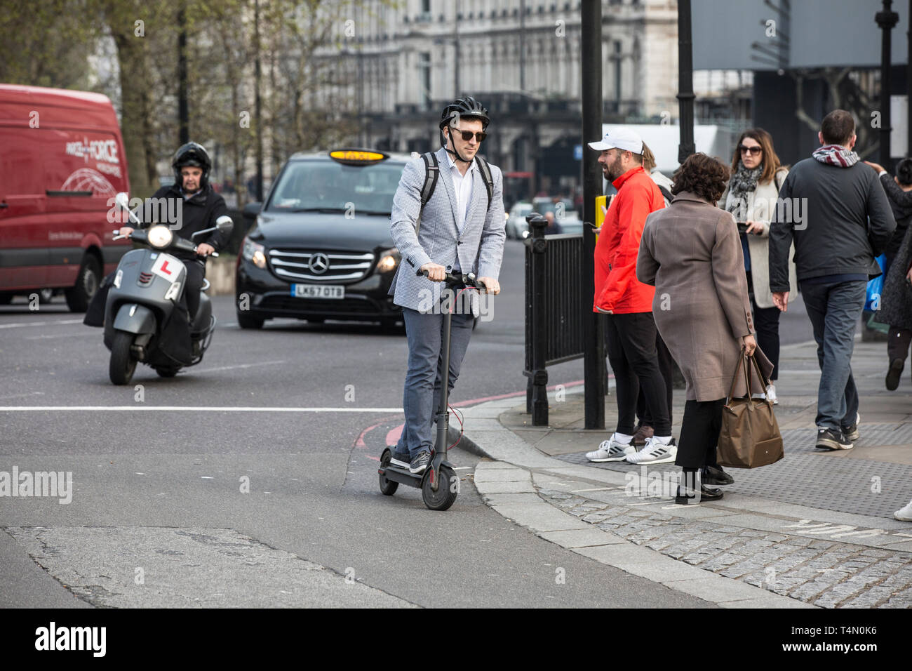 Les navetteurs urbains à l'aide des scooters électriques à Hyde Park Corner Electric comme ministres envisagent de renverser une décennie d'interdiction sur les scooters électriques. Banque D'Images