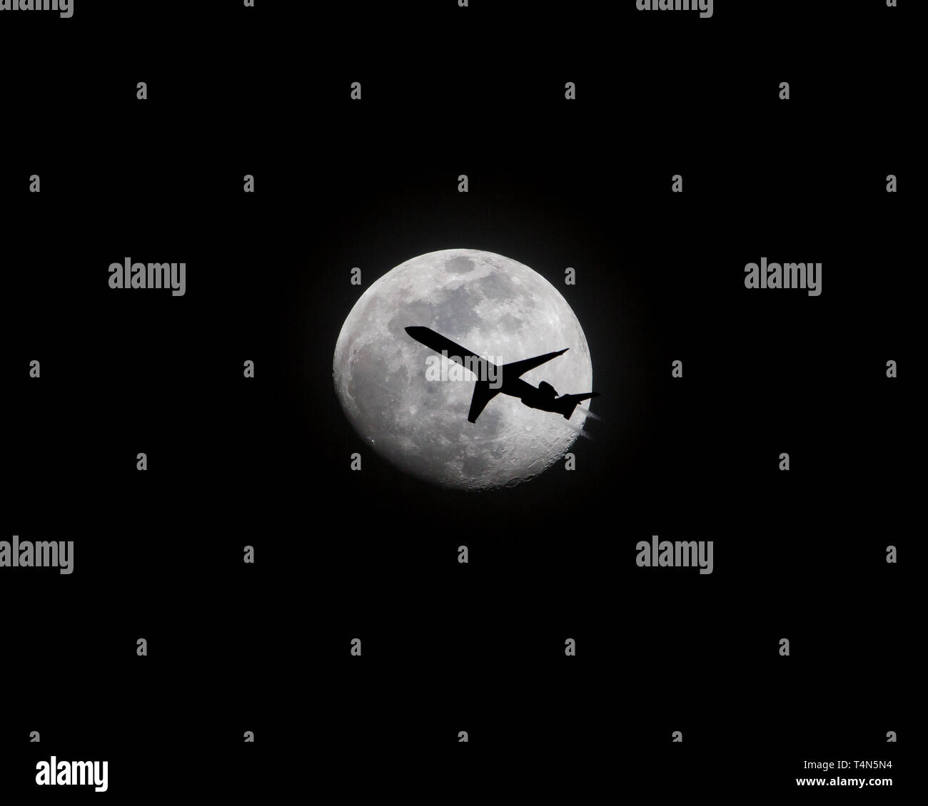 Avion Commercial en passant en face de la Pleine Lune Banque D'Images